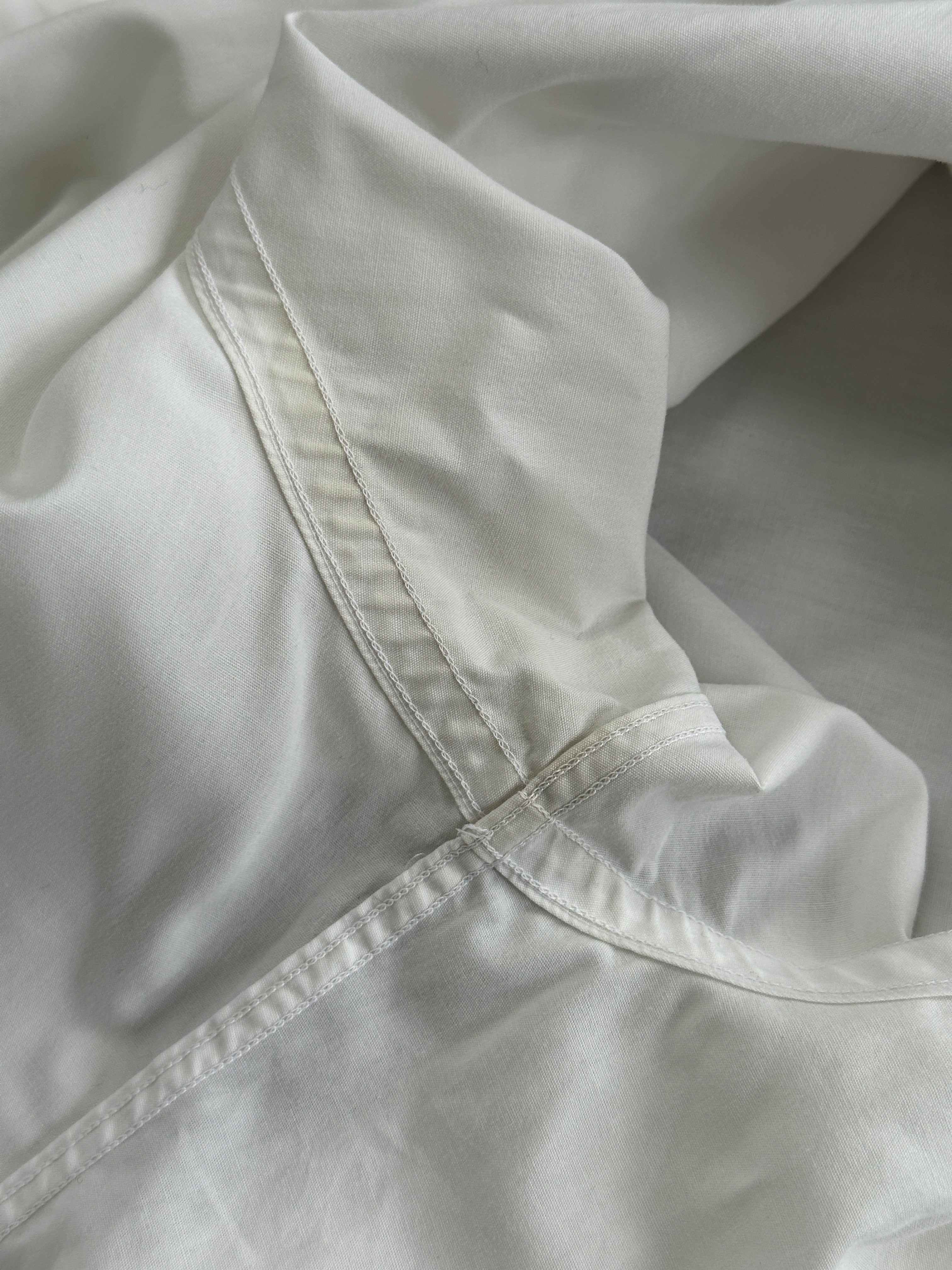 Yves Saint Laurent Pour Homme cotton logo shirt in size L, white with black YSL branding, casual men's shirt on a hanger.