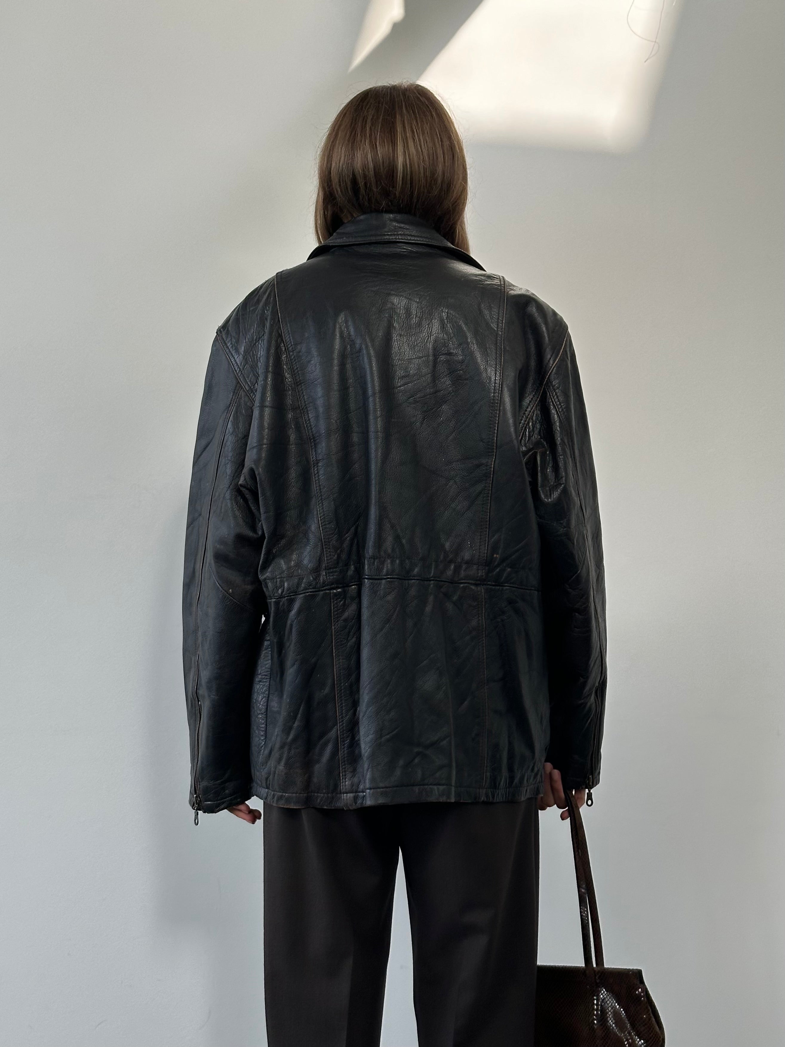 Vintage distressed leather jacket in XL size, featuring a rugged, worn-in look with classic styling and detailed stitching.