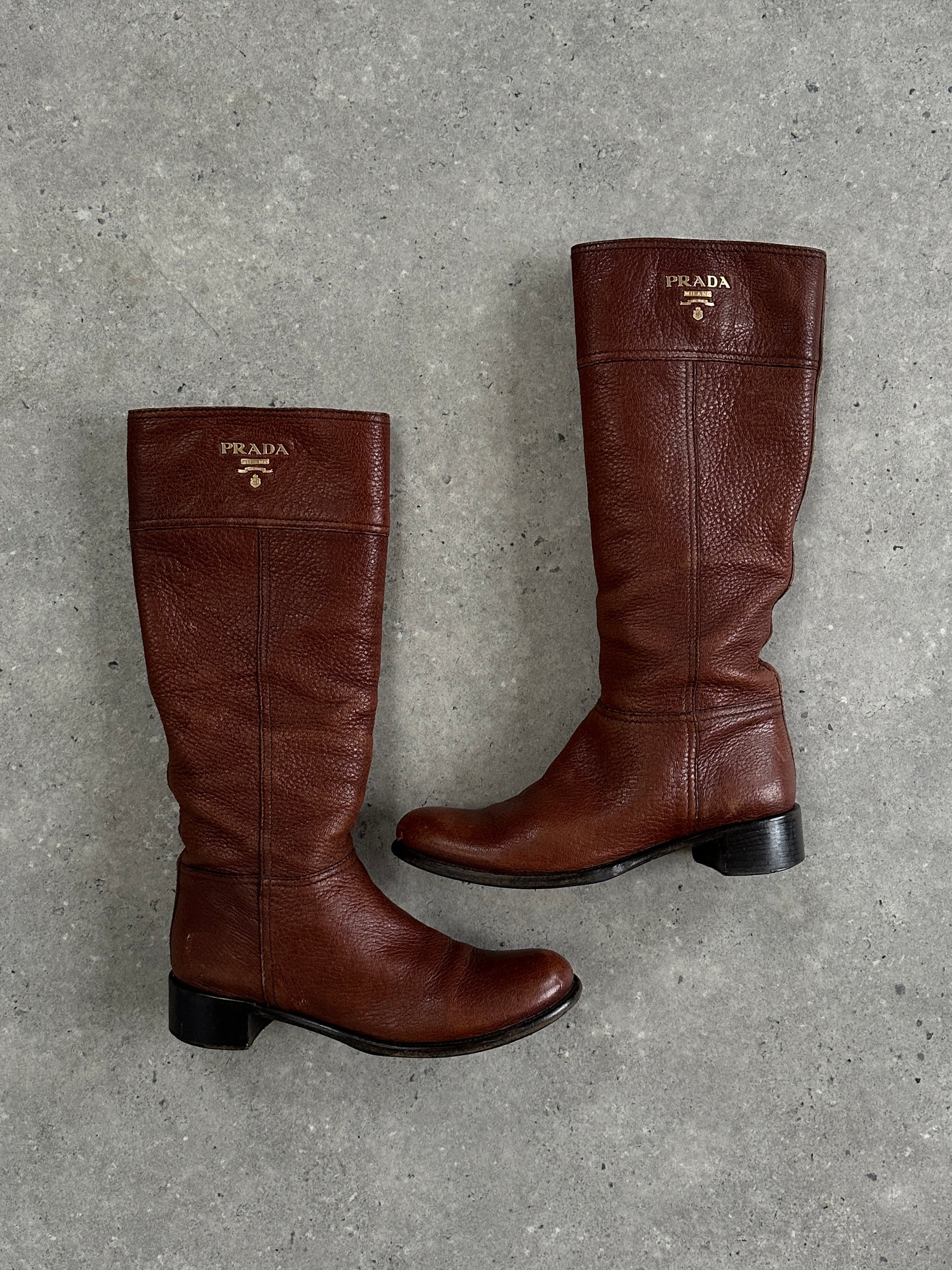 Prada leather logo knee boots in black, UK size 4, with sleek design and branded logo detail on the shaft.