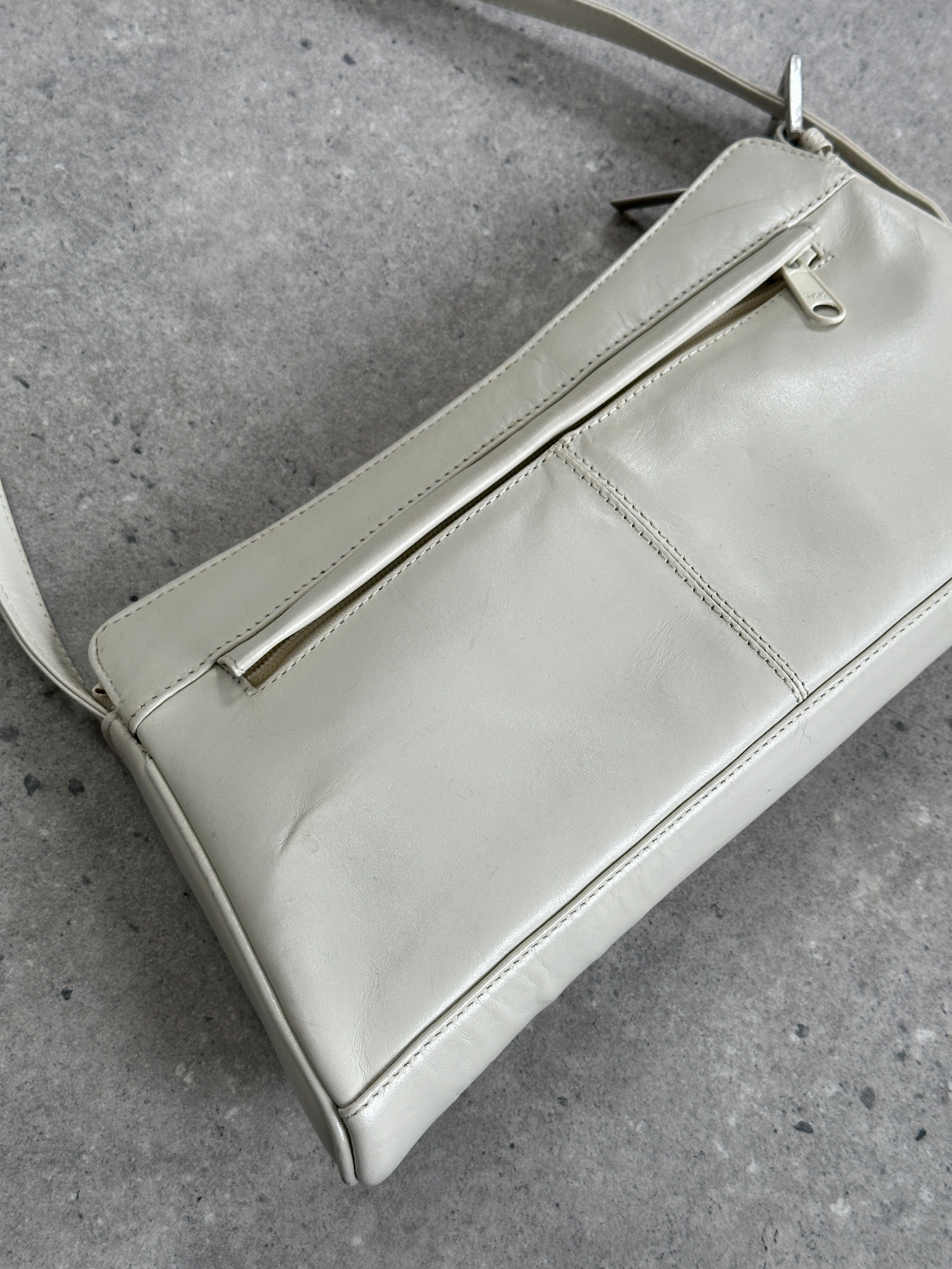 Vintage faux leather A-line shoulder bag with adjustable strap and subtle stitching details.