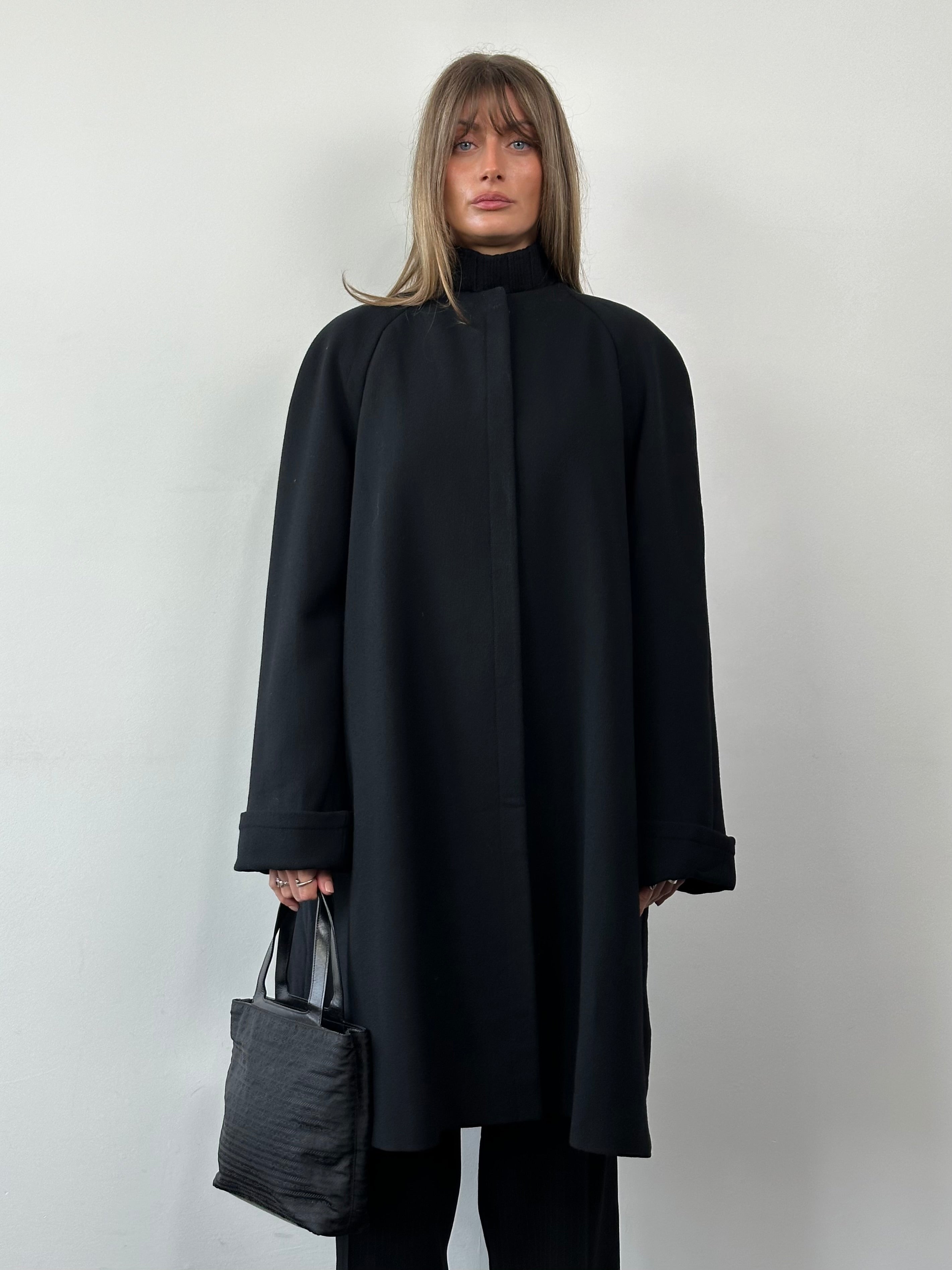 Gianfranco Ferre pure wool A-line coat in XL with a minimal collarless design, shown hanging on a wooden hanger.