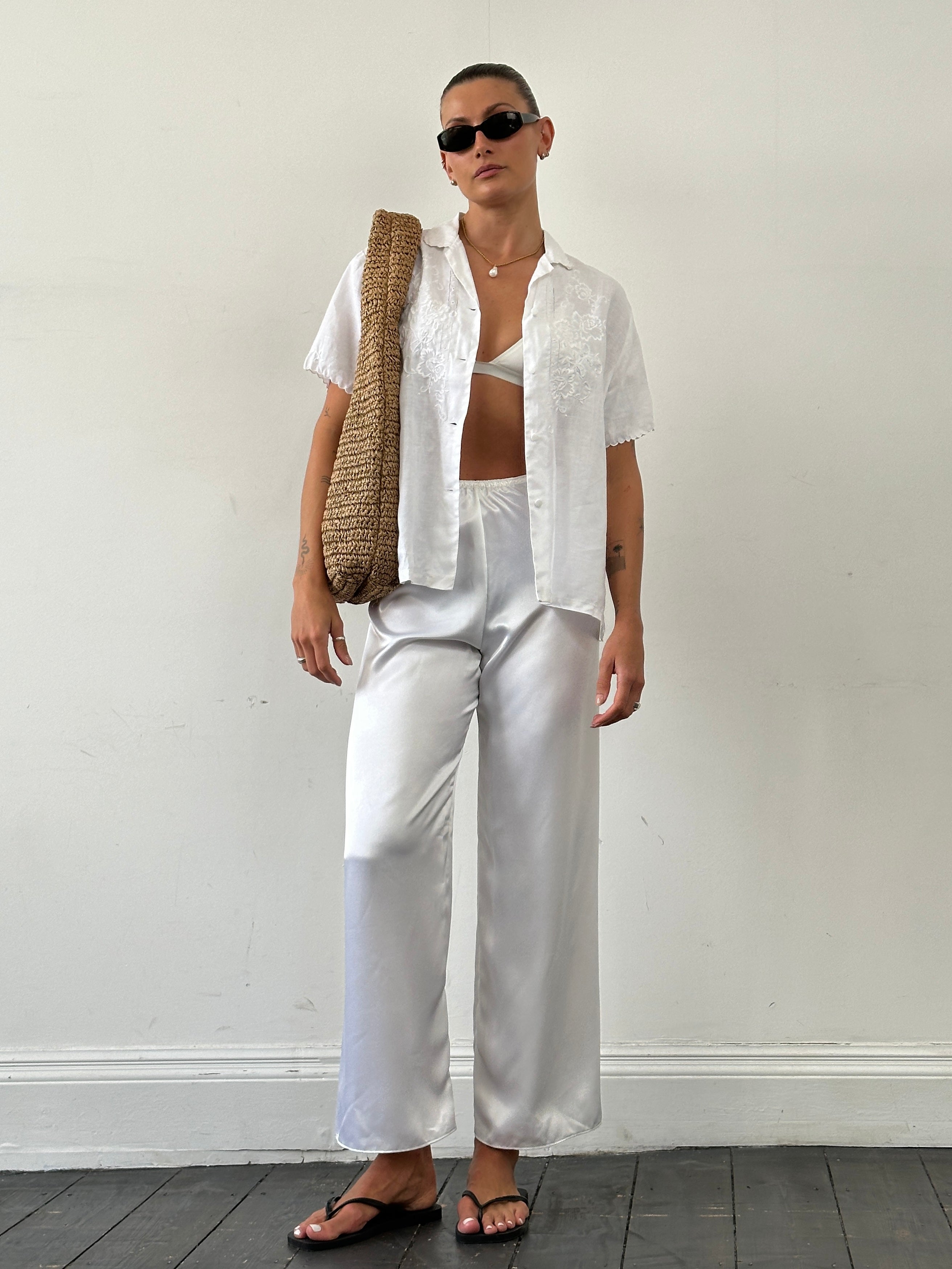 Vintage satin elasticated straight leg trousers in W25-28, shown in a close-up image highlighting the smooth fabric and tailored fit.