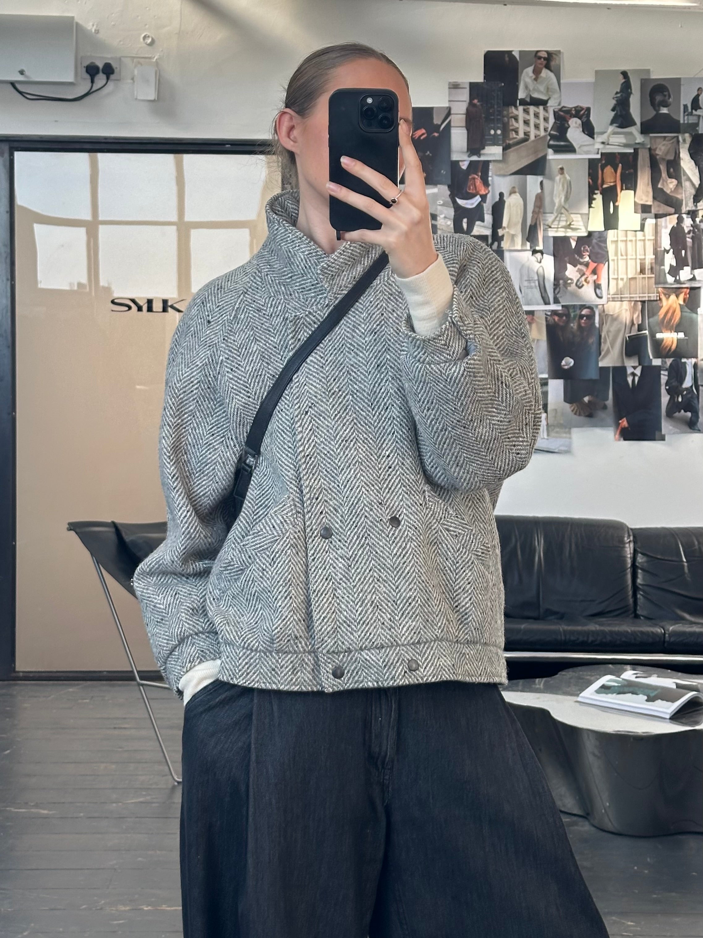 Vintage British 1980s wool herringbone bomber jacket, classic men's outerwear with a retro style and textured fabric.