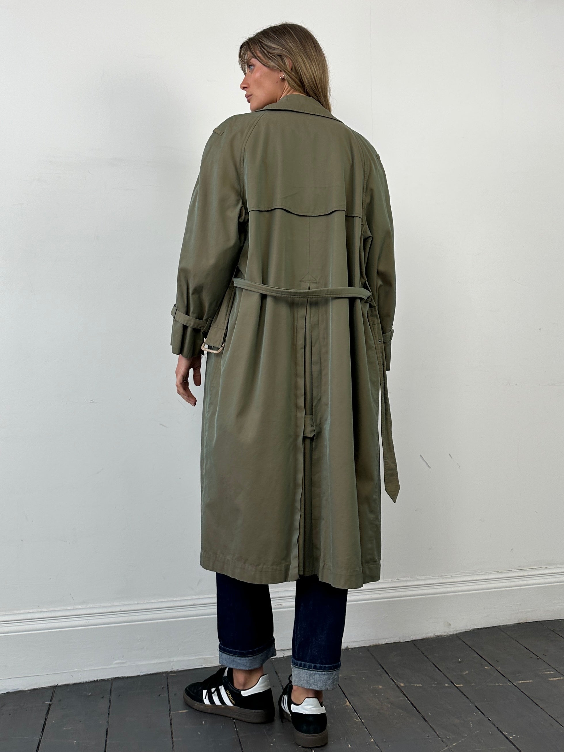 Yves Saint Laurent Rive Gauche double-breasted trench coat in beige, 1980s style, tailored fit with classic collar and belt.