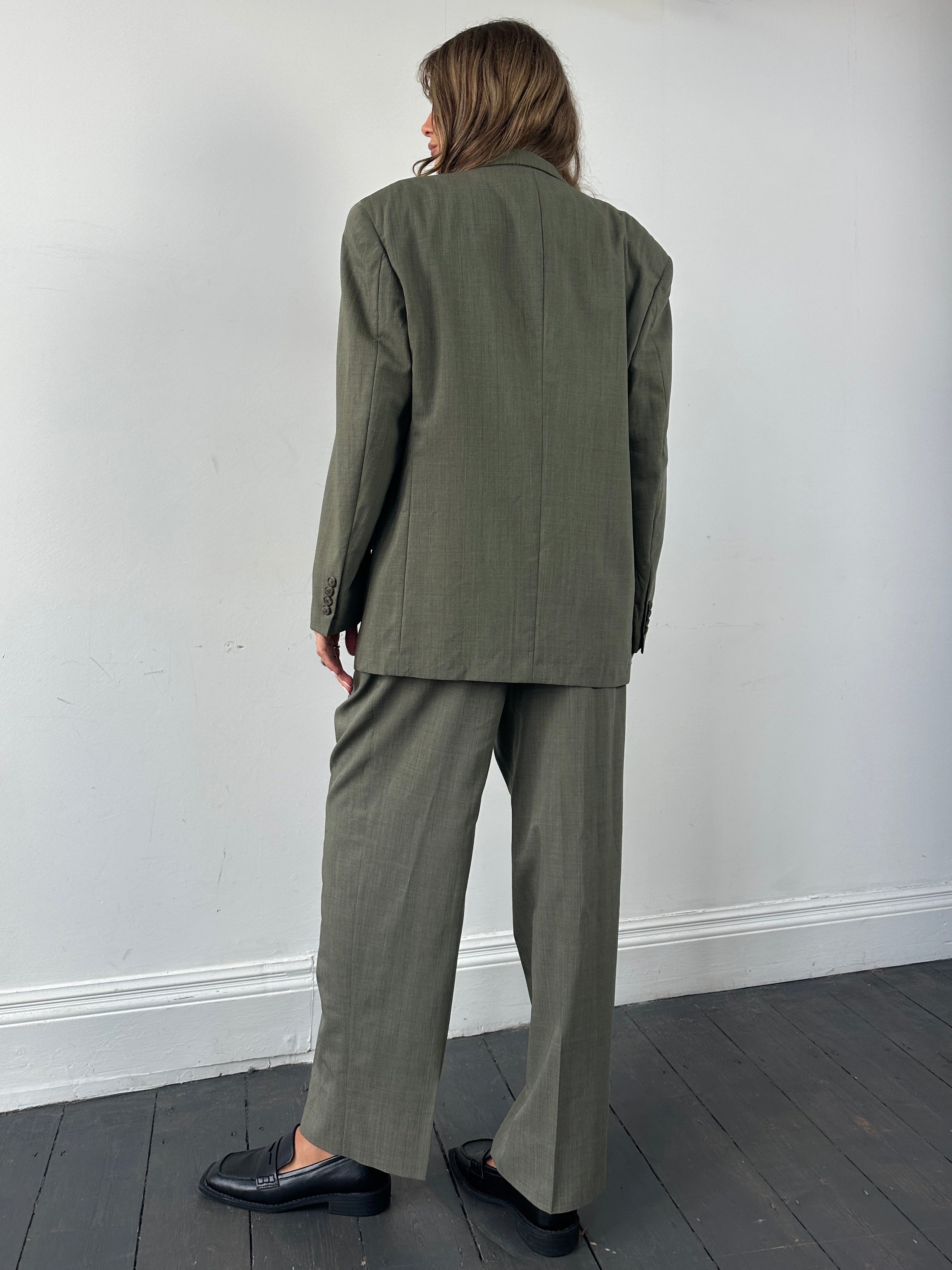Christian Dior pure virgin wool single-breasted jumpsuit in size 42R/W32, shown in a tailored fit with lapel details.