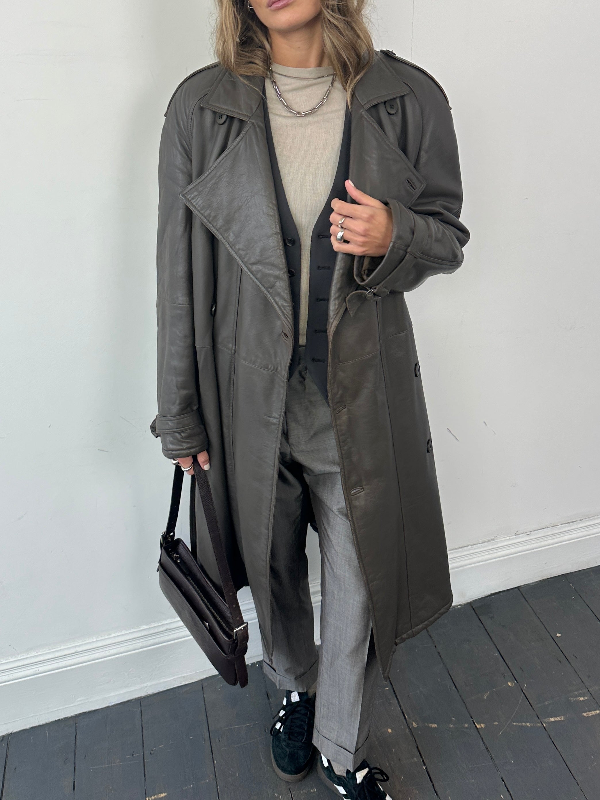 Vintage leather double-breasted belted trench coat in size L, showcasing classic style and structured design.