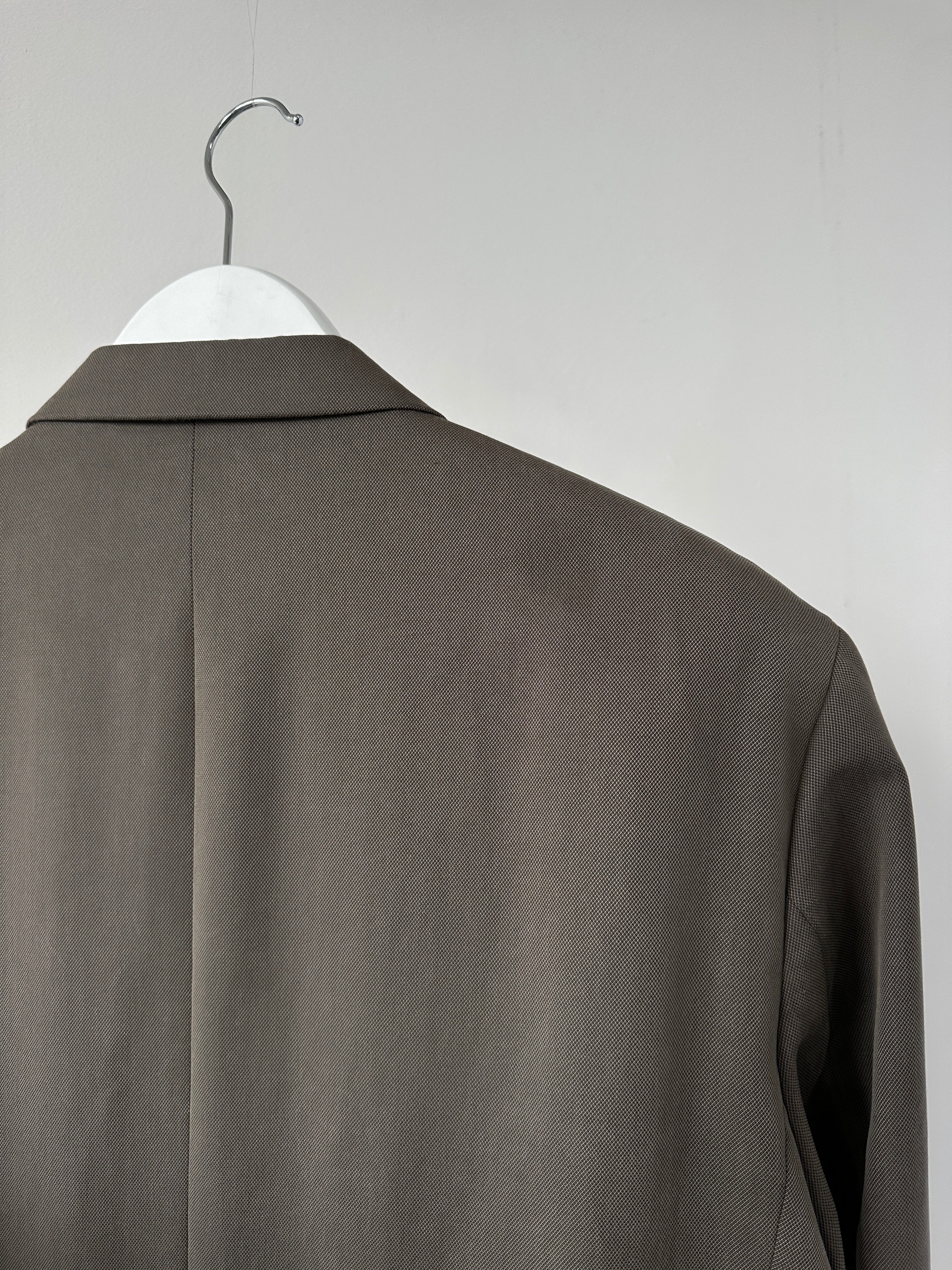 Vintage relaxed single-breasted blazer in size L/XL, showing classic lapels and tailored fit in a neutral fabric.