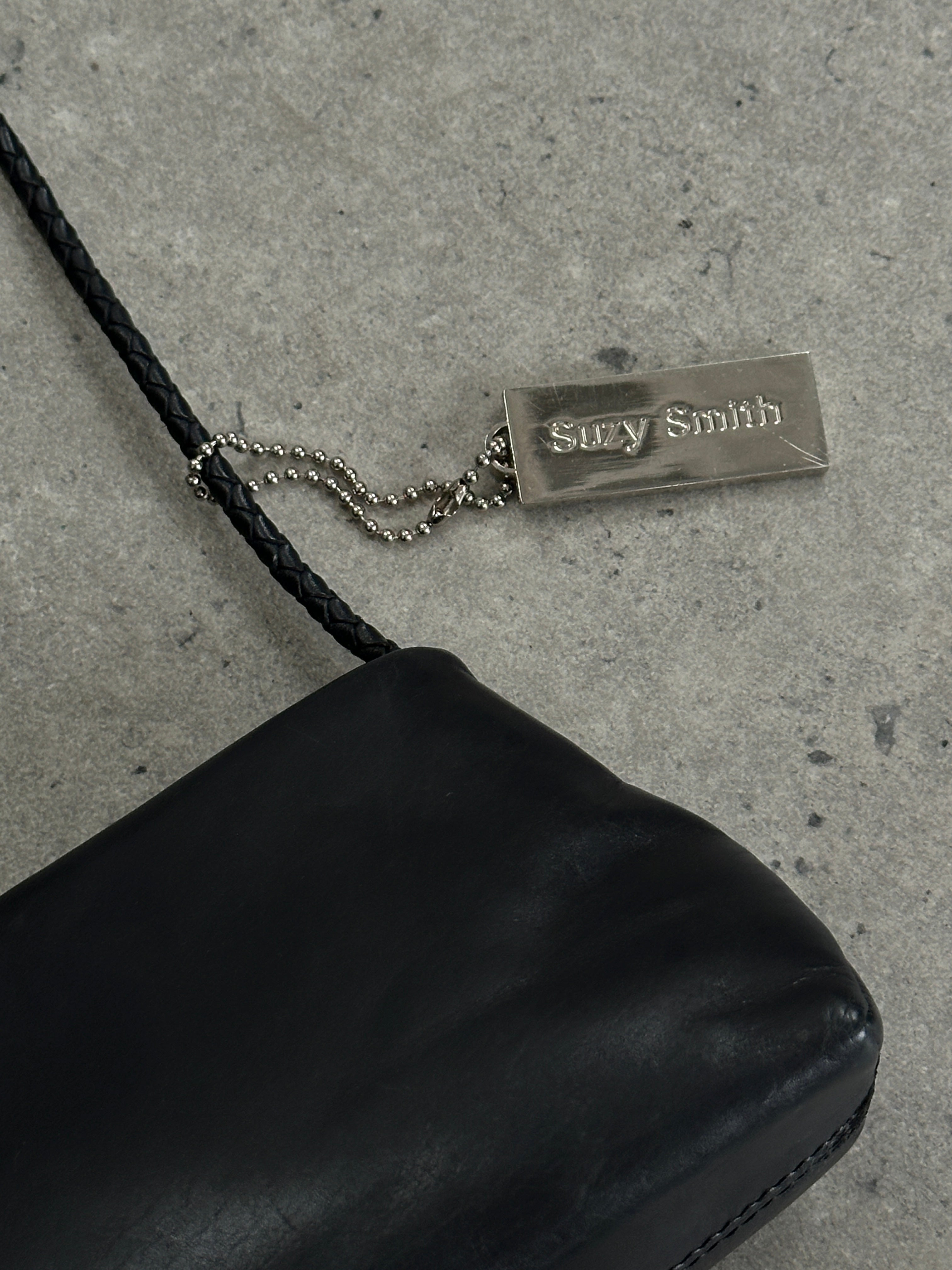 Vintage leather shoulder bag with adjustable strap and antique finish, showcasing a classic, stylish design.