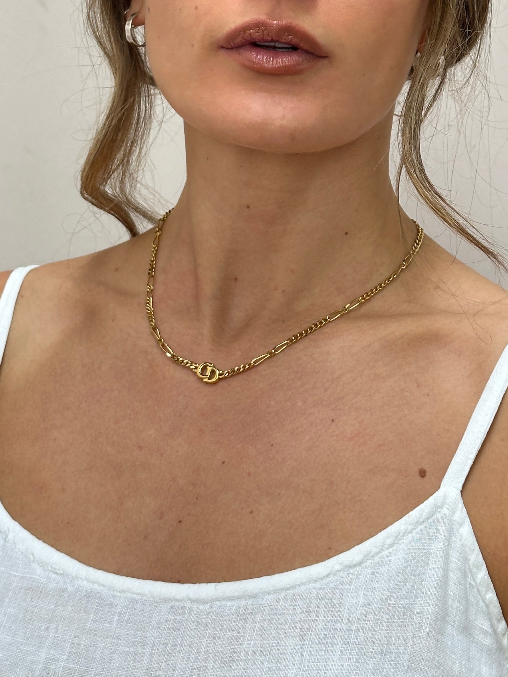 Christian Dior gold plated 18-inch logo pendant necklace showing the elegant chain and signature Dior logo pendant.