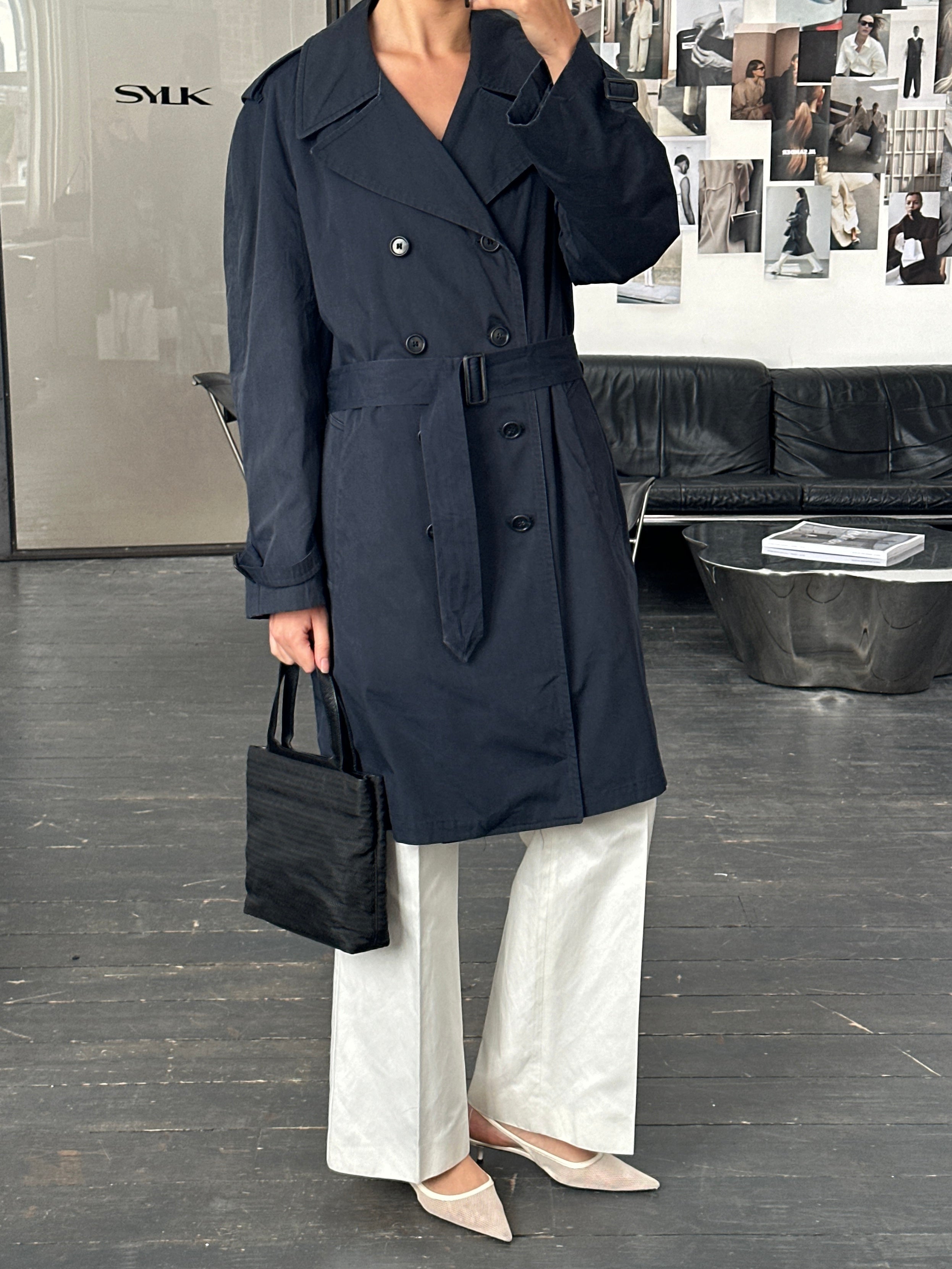 London Fog 1980s double-breasted belted cotton trench coat, L/XL, shown on a hanger with classic beige color and tailored design.