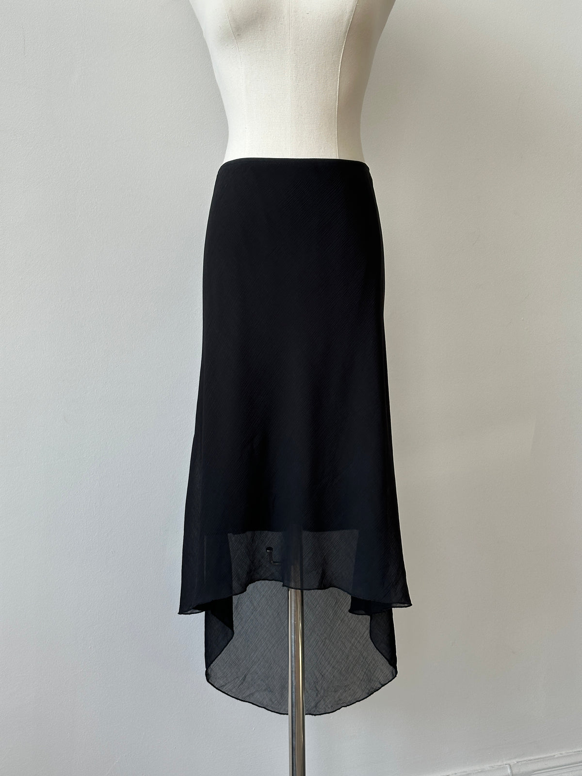 Vintage 1990s USA asymmetric midi skirt in denim fabric, featuring a unique uneven hem and classic style.
