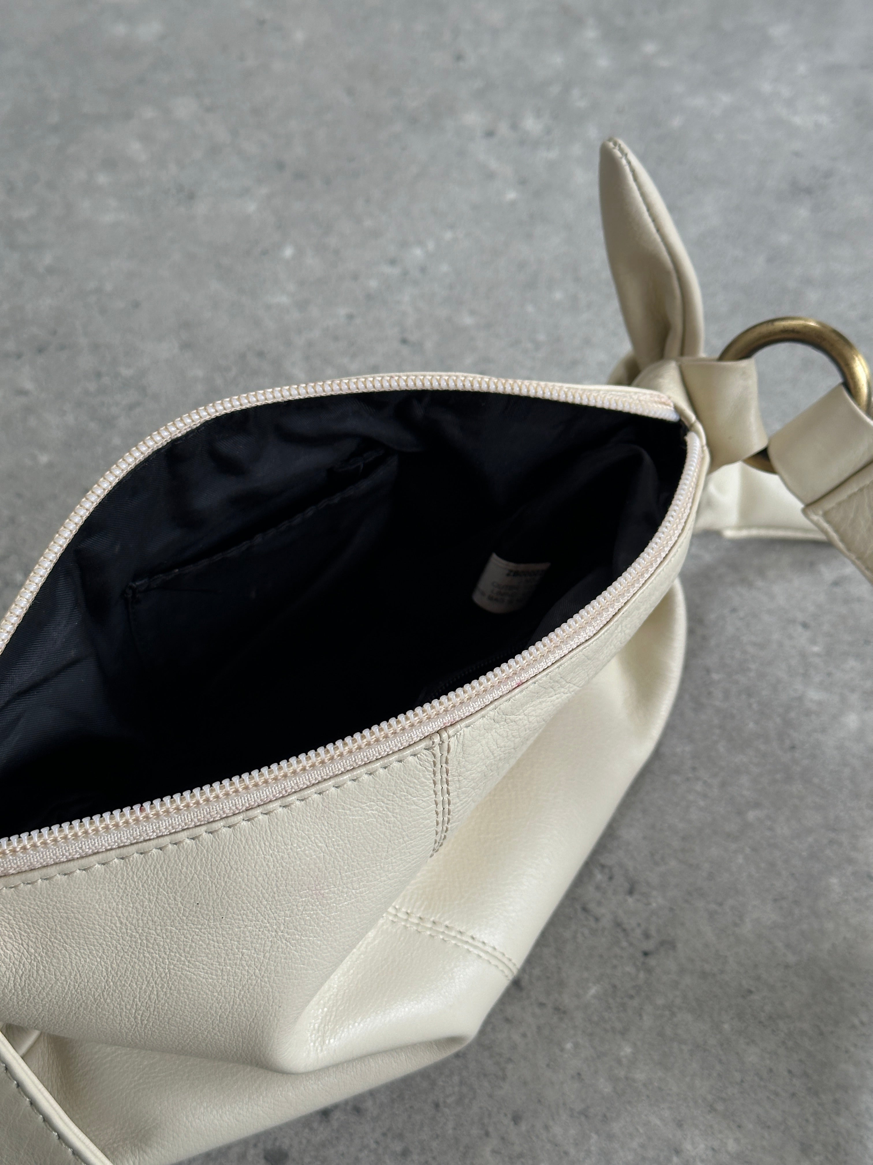 Vintage soft leather knot shoulder bag with adjustable strap and classic design, featuring a spacious interior and stylish finish.