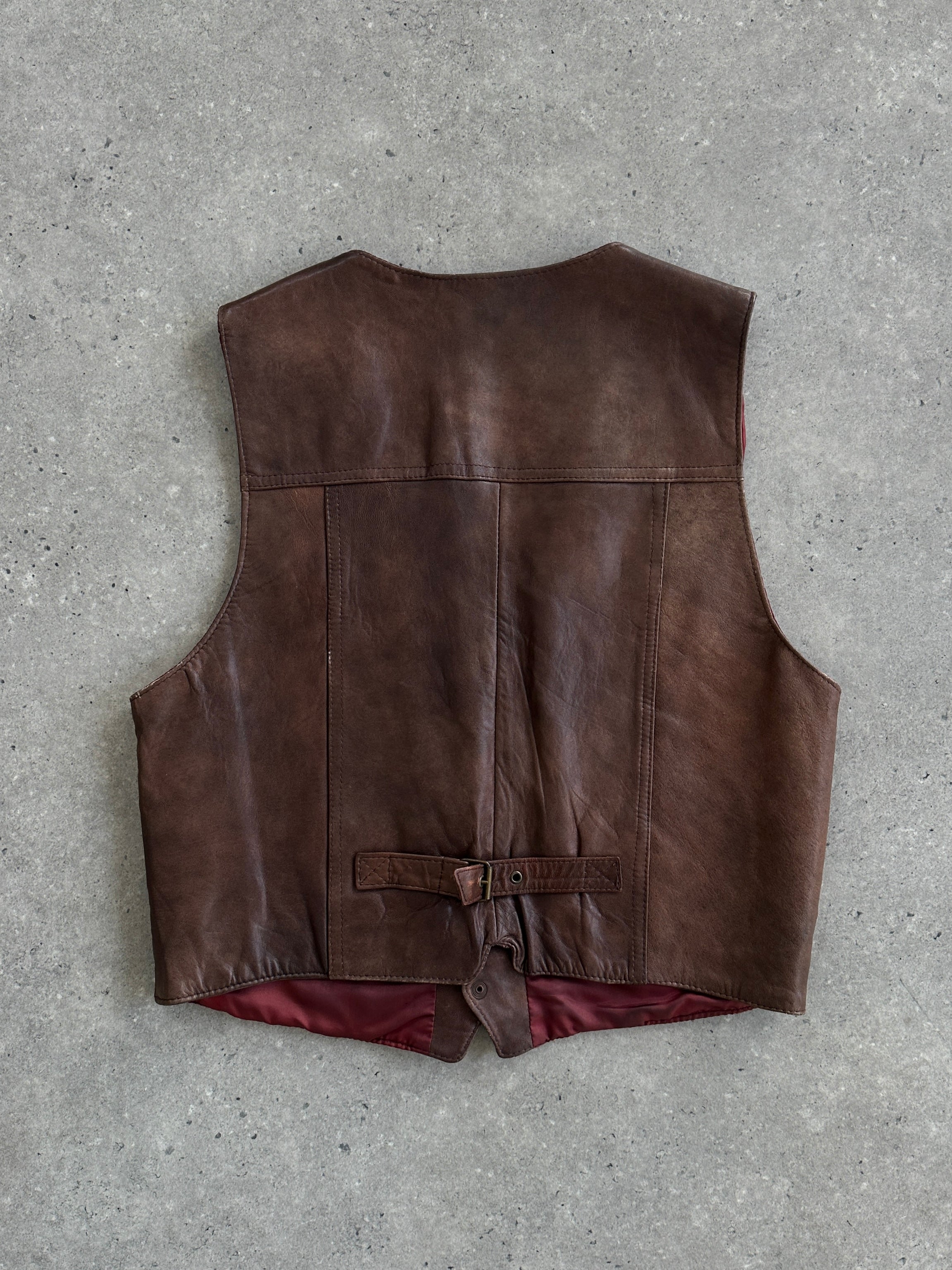 Italian Vintage aged leather waistcoat by Vintage, featuring a classic design and natural patina, size large.