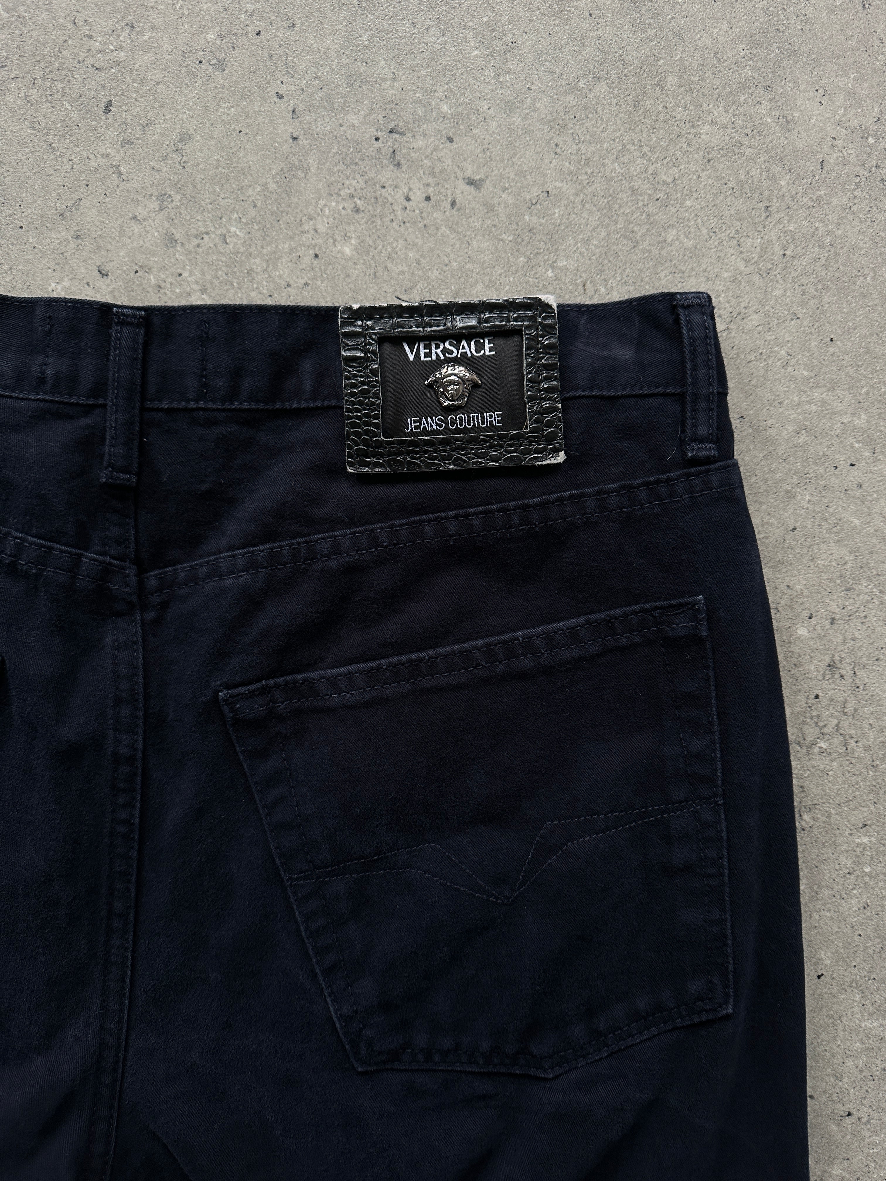 Versace tall pure cotton tapered leg denim jeans in W34, showing classic blue wash and waistband with belt loops.