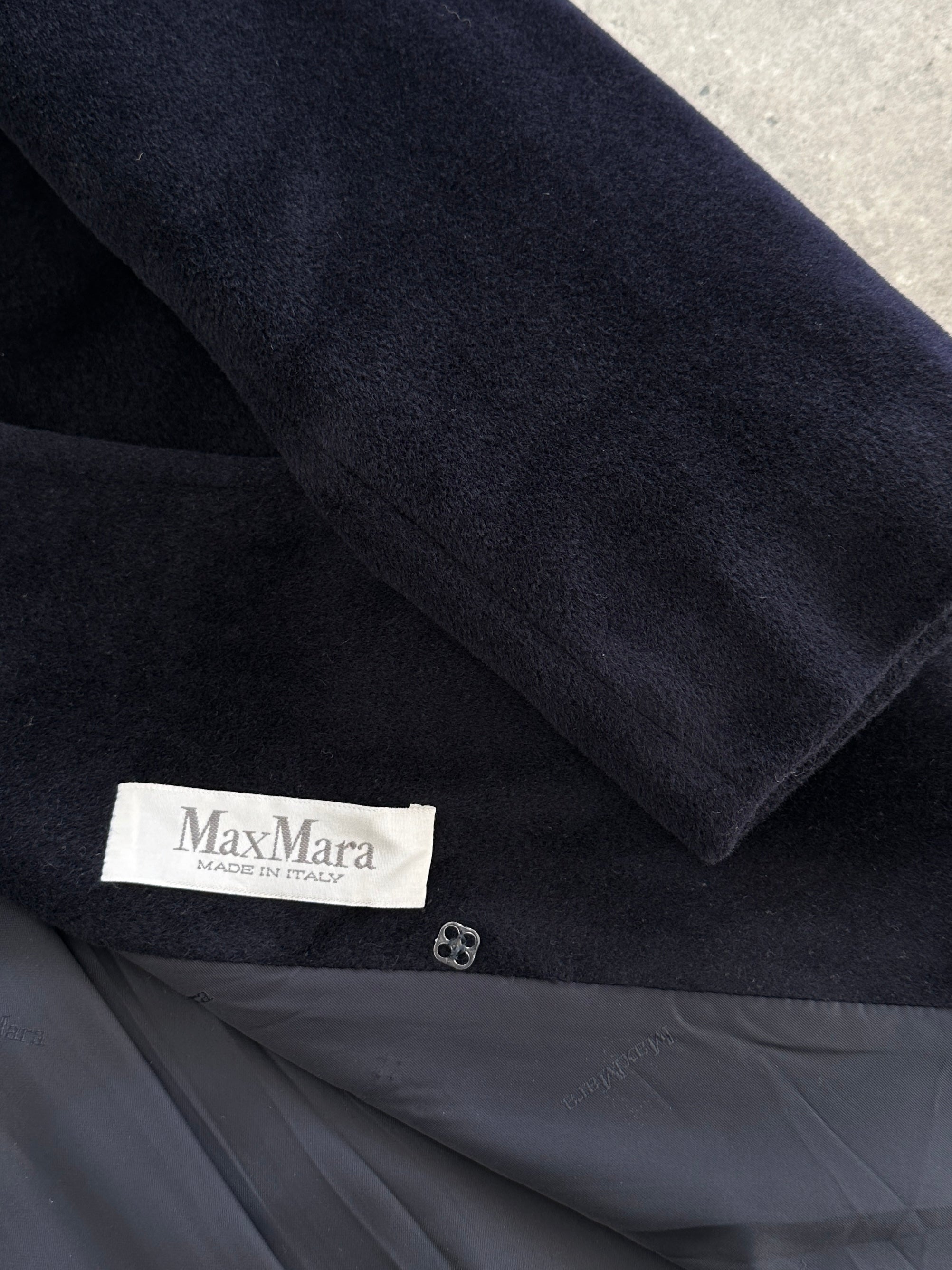 Max Mara pure wool double-breasted coat in size M, shown on a hanger with a classic tailored fit and neutral color.