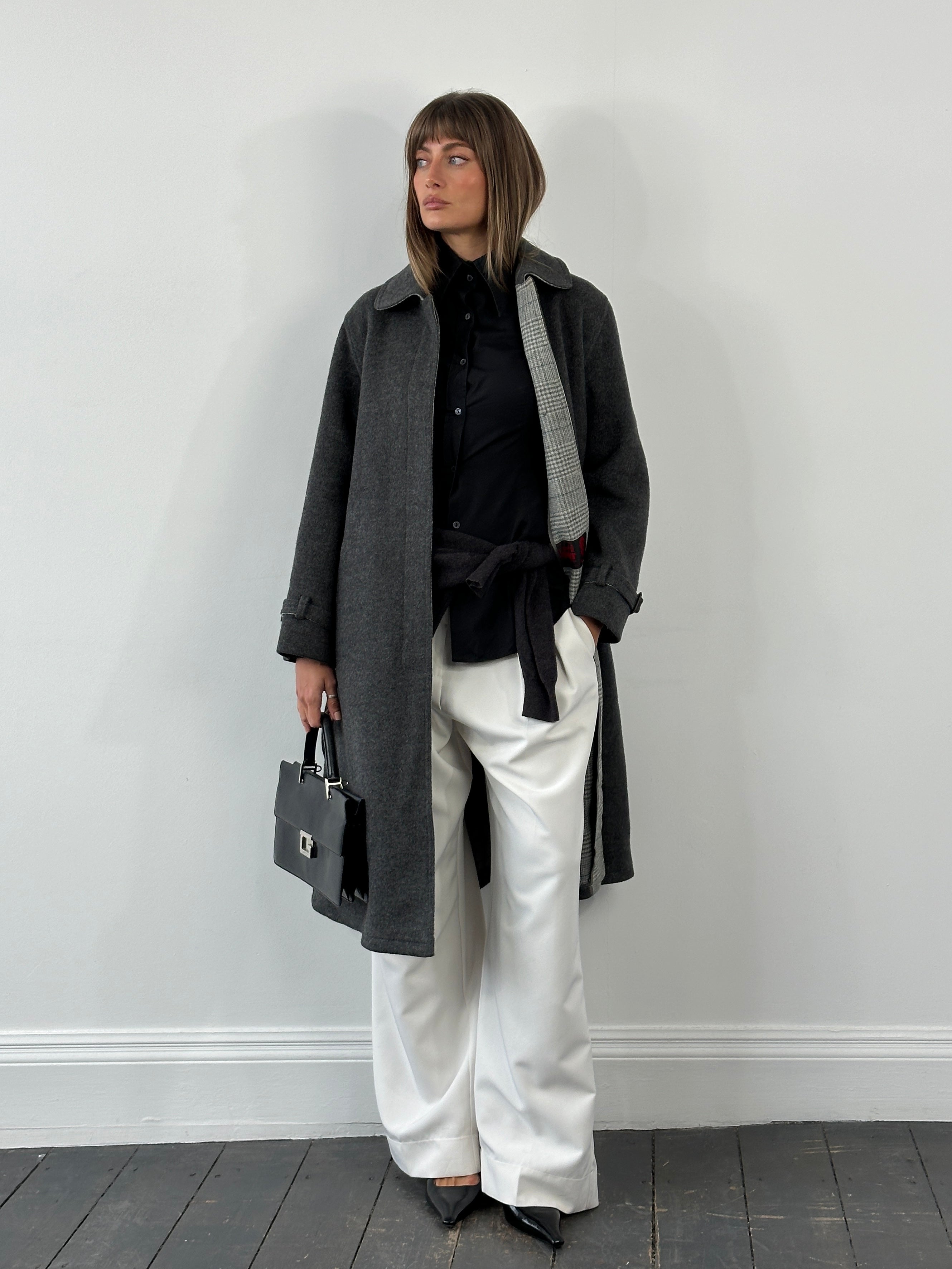 Vintage 1980s wool belted coat with concealed placket, shown in classic style, featuring a tailored fit and retro design.
