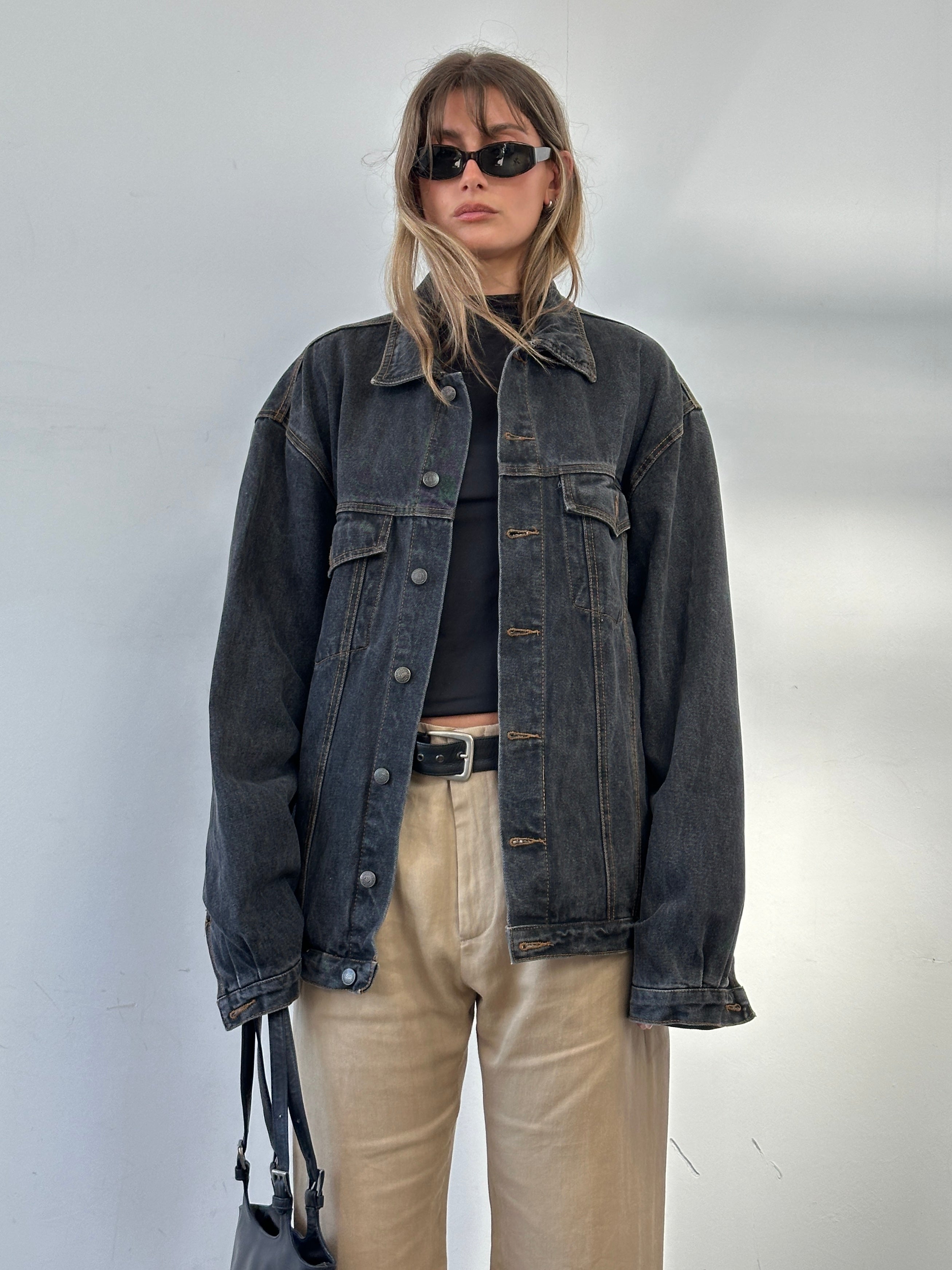 Vintage oversized washed denim jacket in XXL, showing distressed details and classic denim texture.