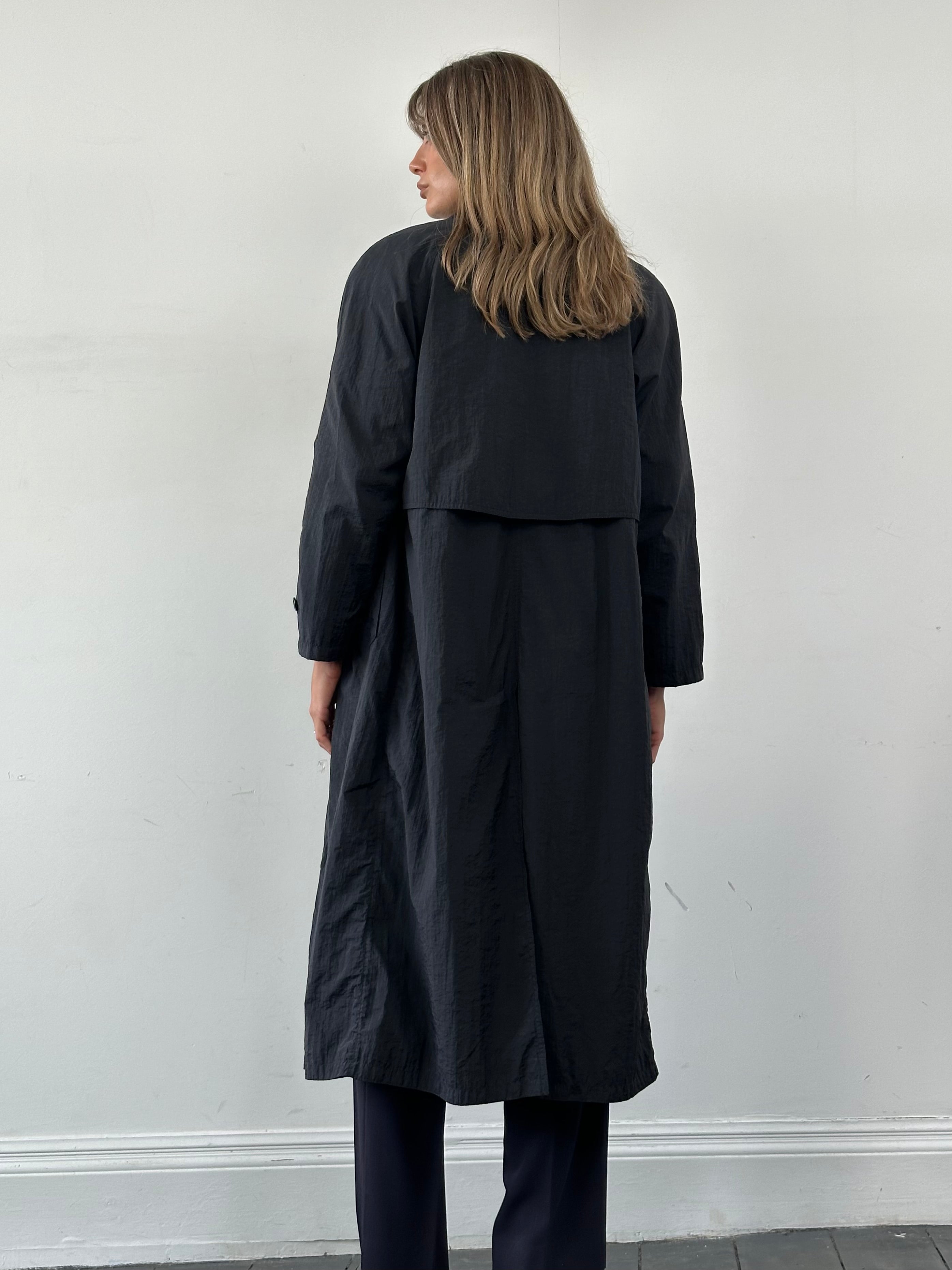 Vintage nylon trench coat with concealed placket, in size small, featuring a classic design and lightweight fabric.