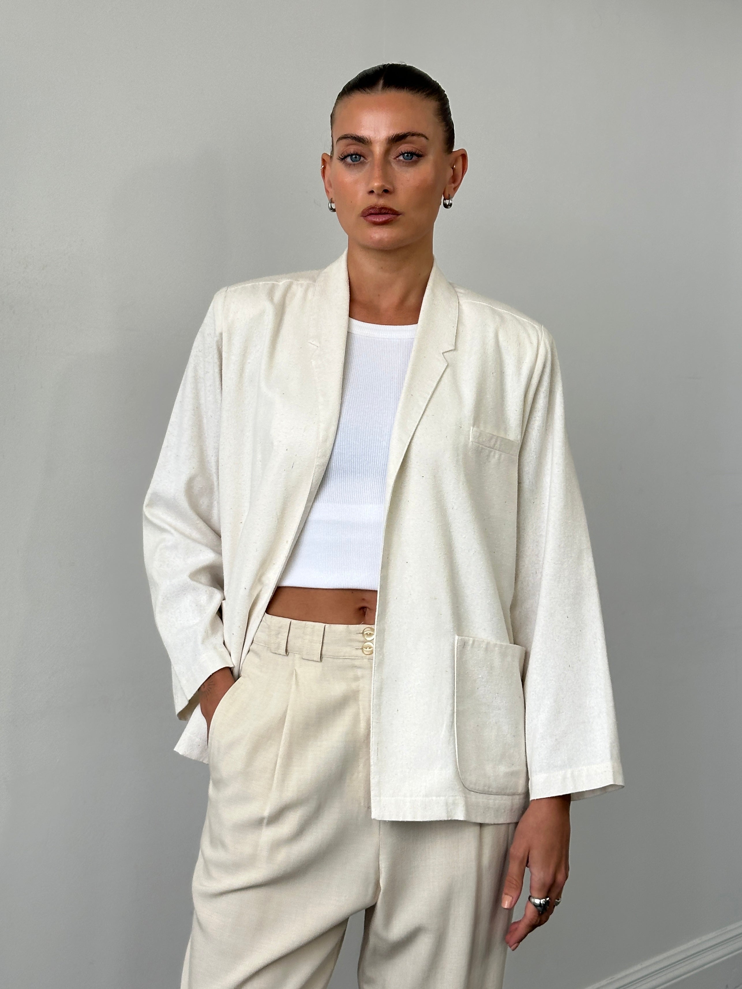 Vintage pure silk minimal blazer in S/M, tailored fit with sleek design, displayed on a hanger against a neutral background.