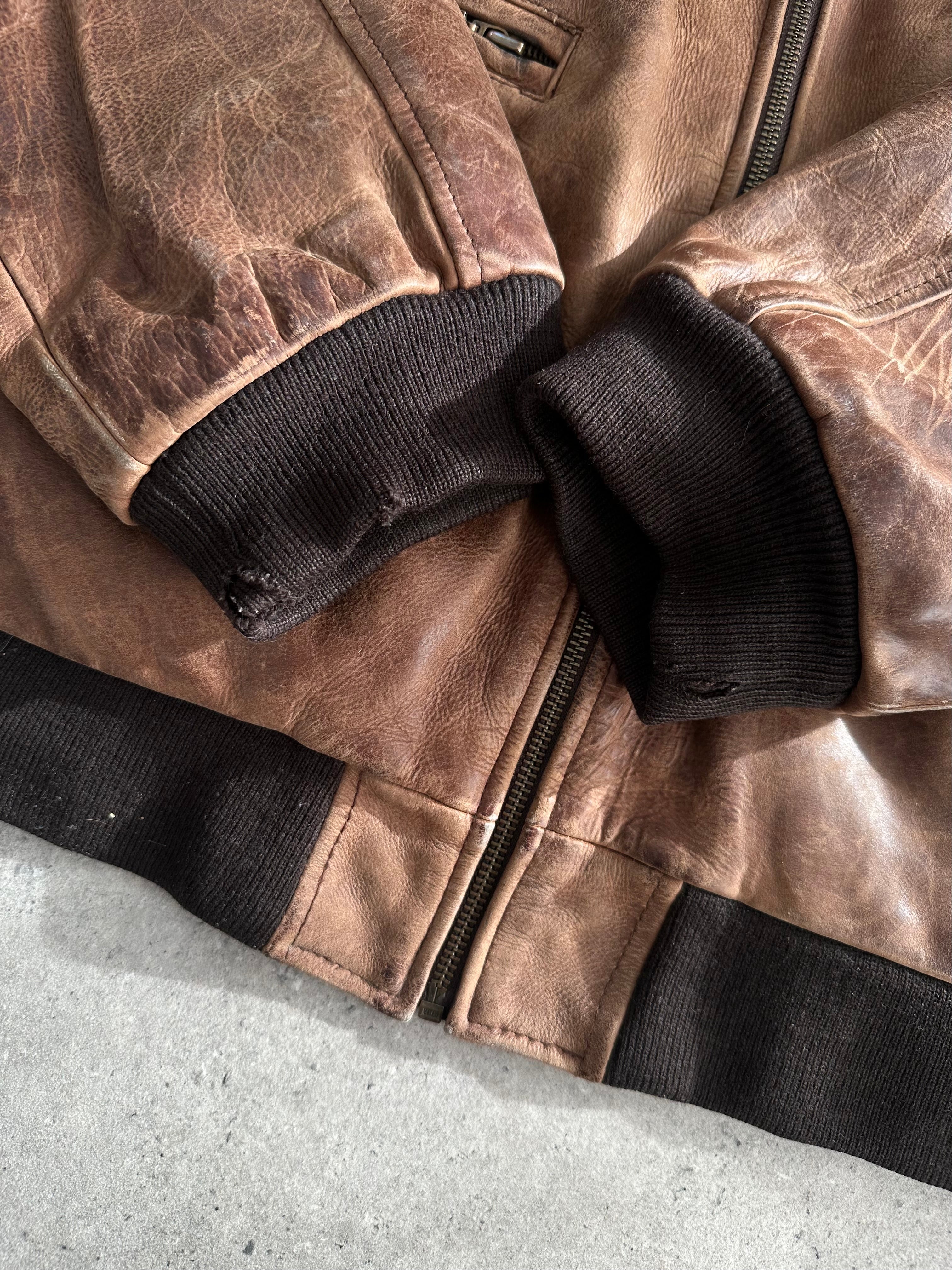 Vintage distressed leather bomber jacket in XL with a rugged, worn-in look, featuring classic design and metal zipper details.