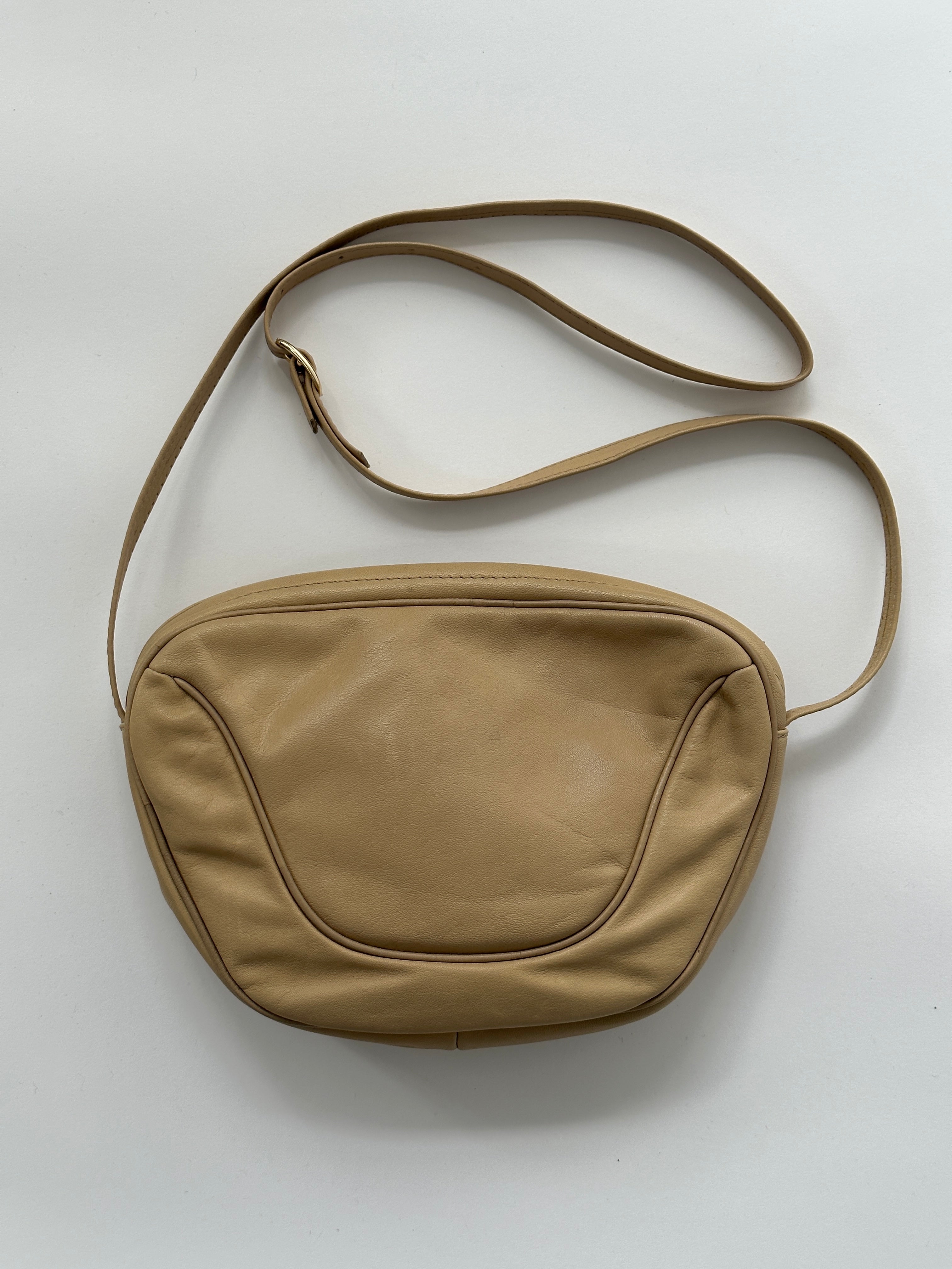 Vintage faux leather crossbody bag with adjustable strap and gold-tone hardware, stylish and compact for everyday use.