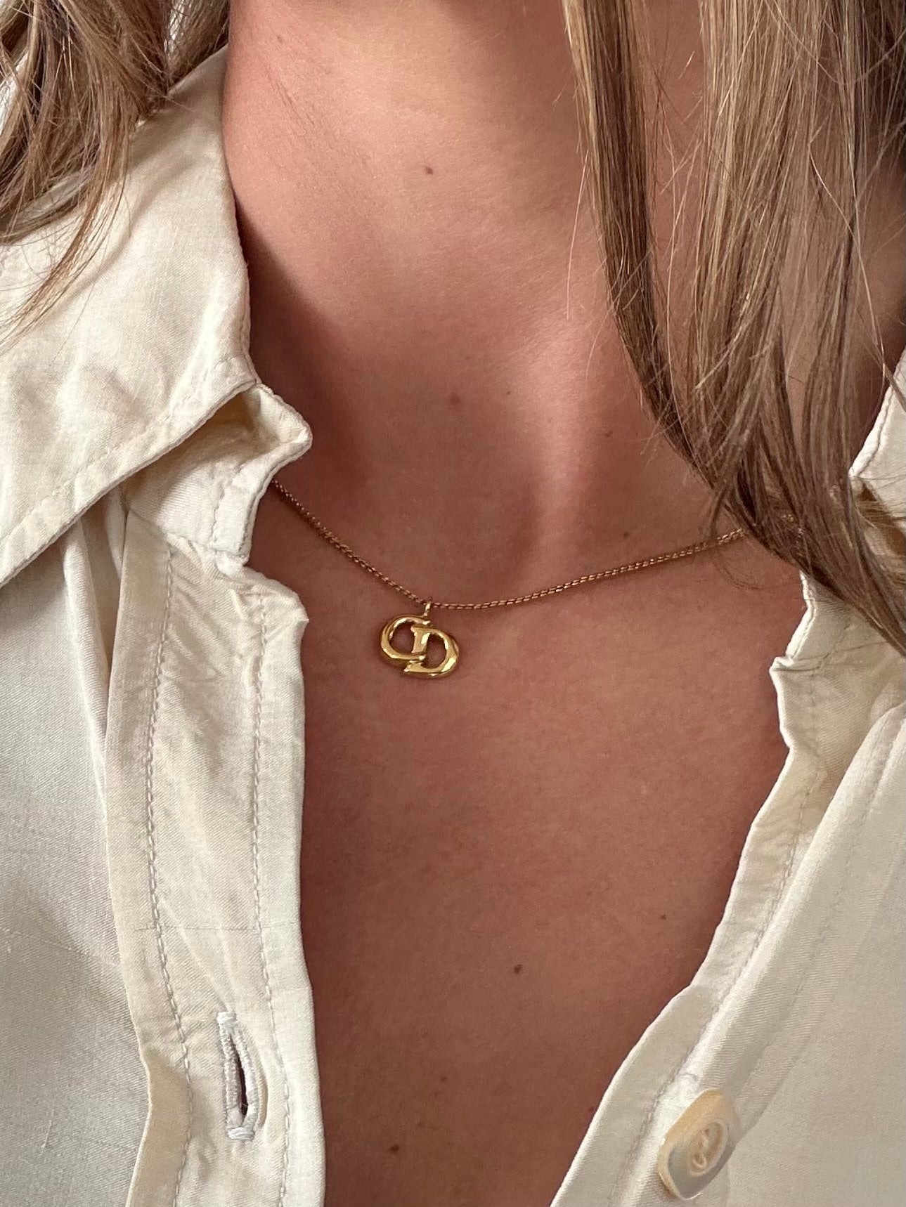 Christian Dior 16-inch gold plated logo pendant necklace with a sleek chain and iconic Dior charm.
