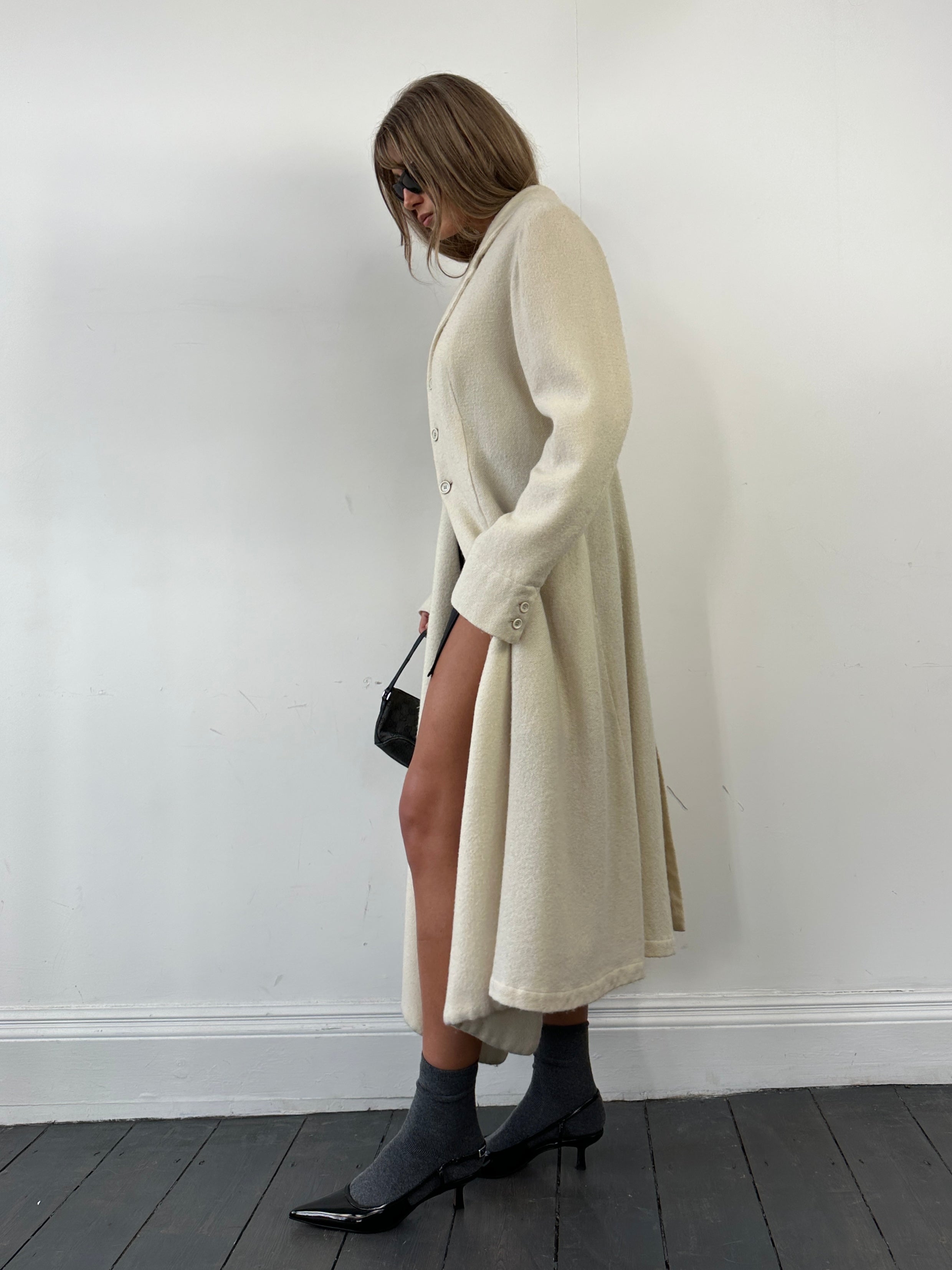 Comme des Garçons 90s unlined pure wool waterfall coat in size M, shown hanging with a draped waterfall front and neutral color.