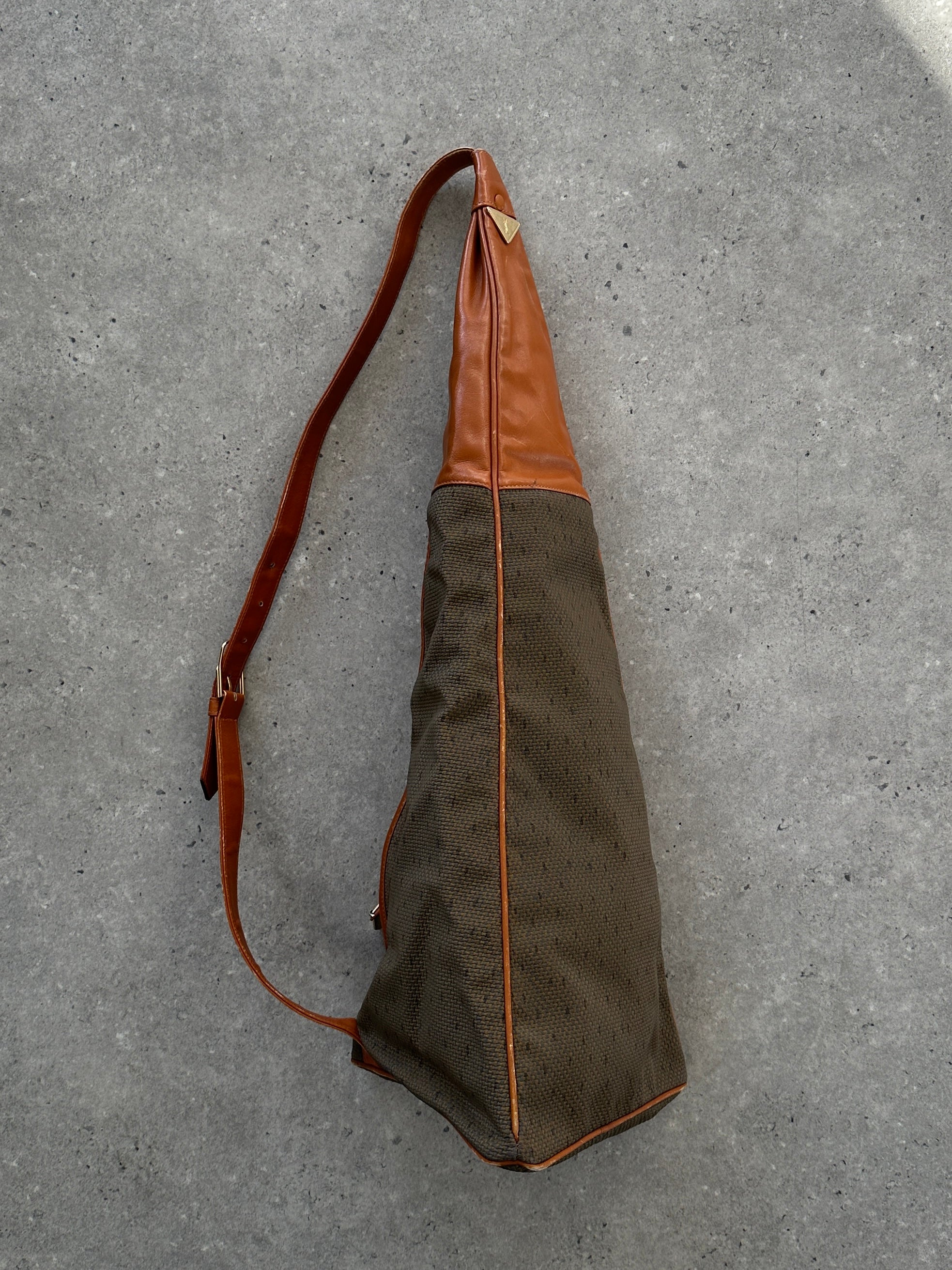 Yves Saint Laurent Paris 80s leather sling bag with sleek design and adjustable strap, featuring classic black leather and YSL logo accents.