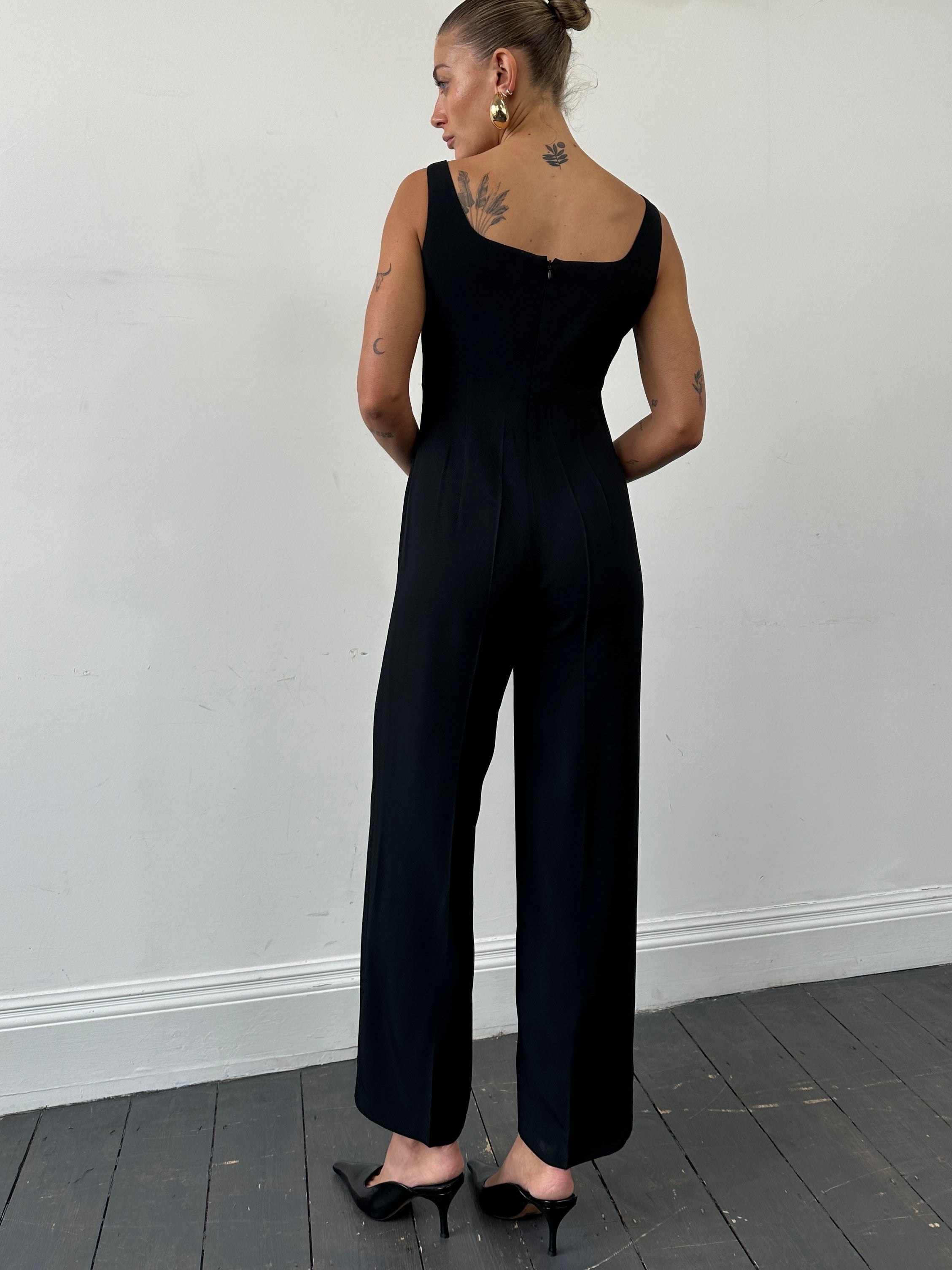 Max Mara square neck jumpsuit in black, featuring sleeveless design and tailored fit, size S/M, displayed on a hanger.