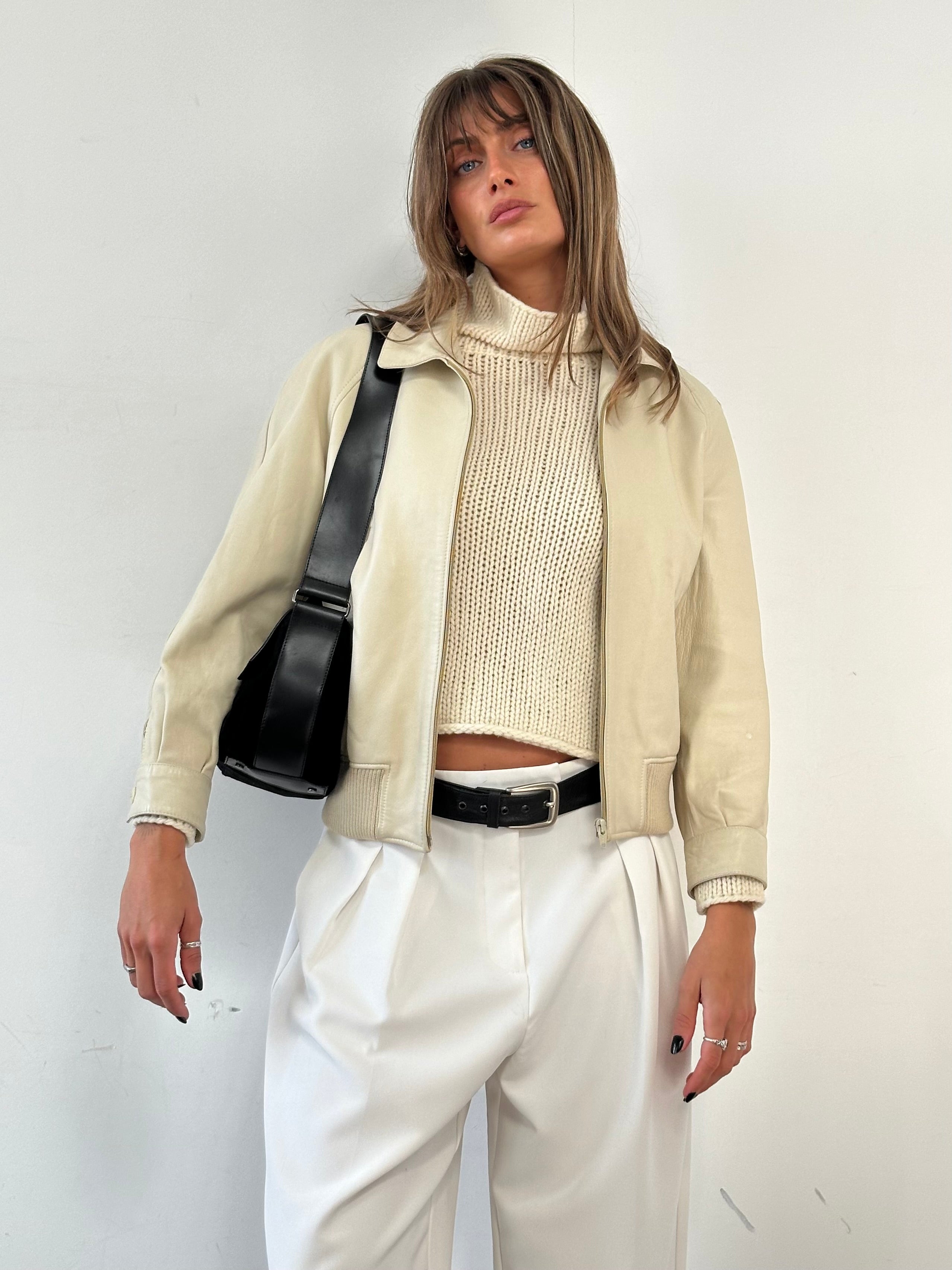 Vintage leather bomber jacket in size S, featuring classic design, ribbed collar, and durable construction.