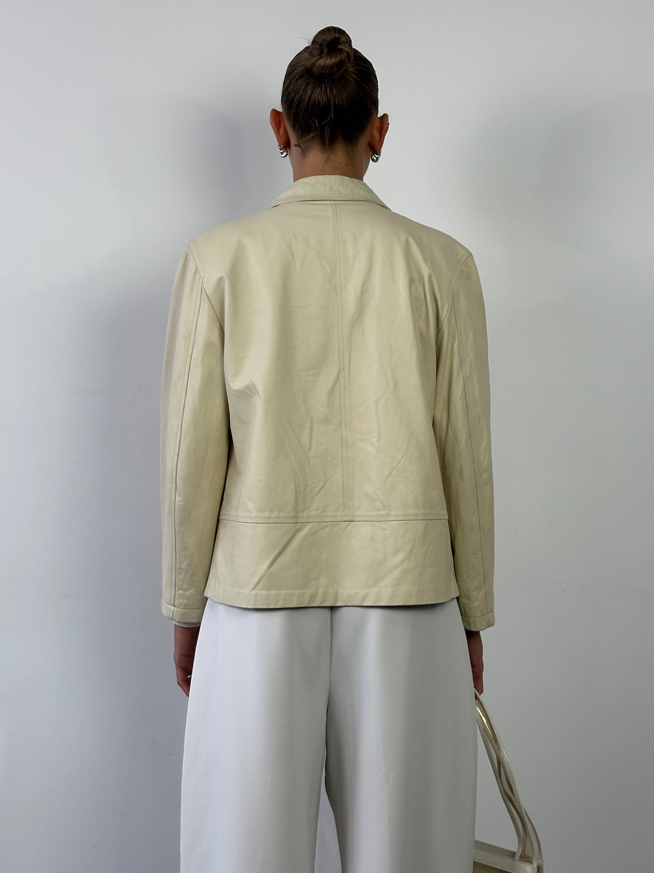 Burberry boxy leather jacket in black, featuring a tailored fit and classic design, displayed on a hanger.