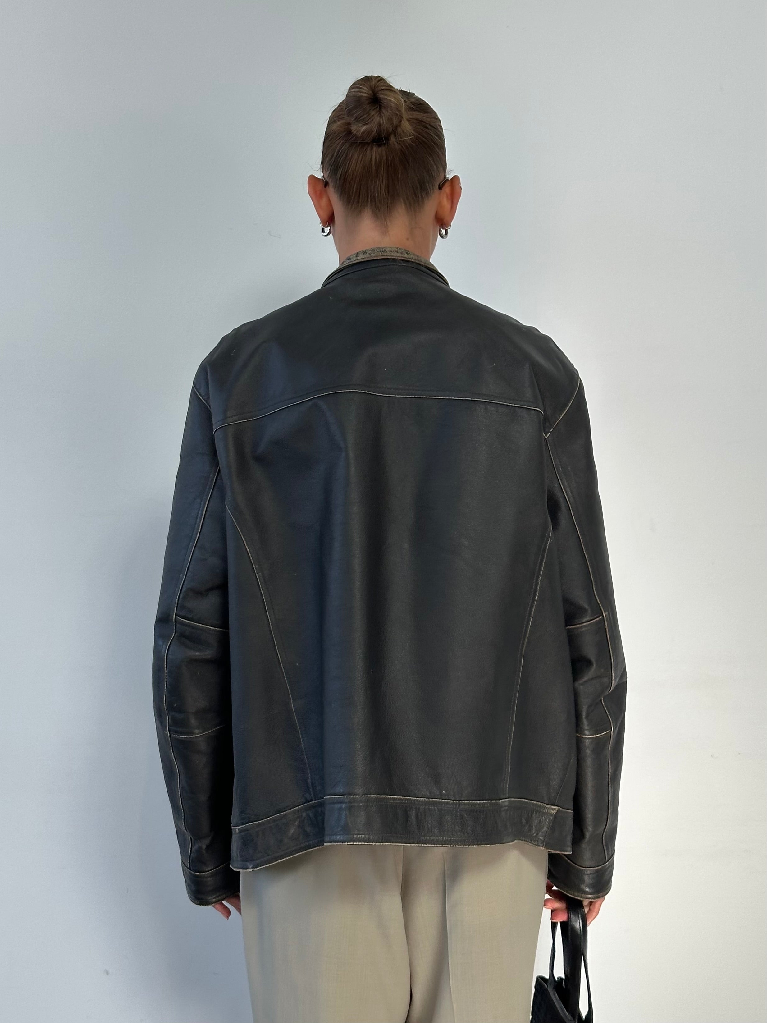 Guess distressed moto leather jacket in size large, featuring a rugged design with zippers and a worn-in look.