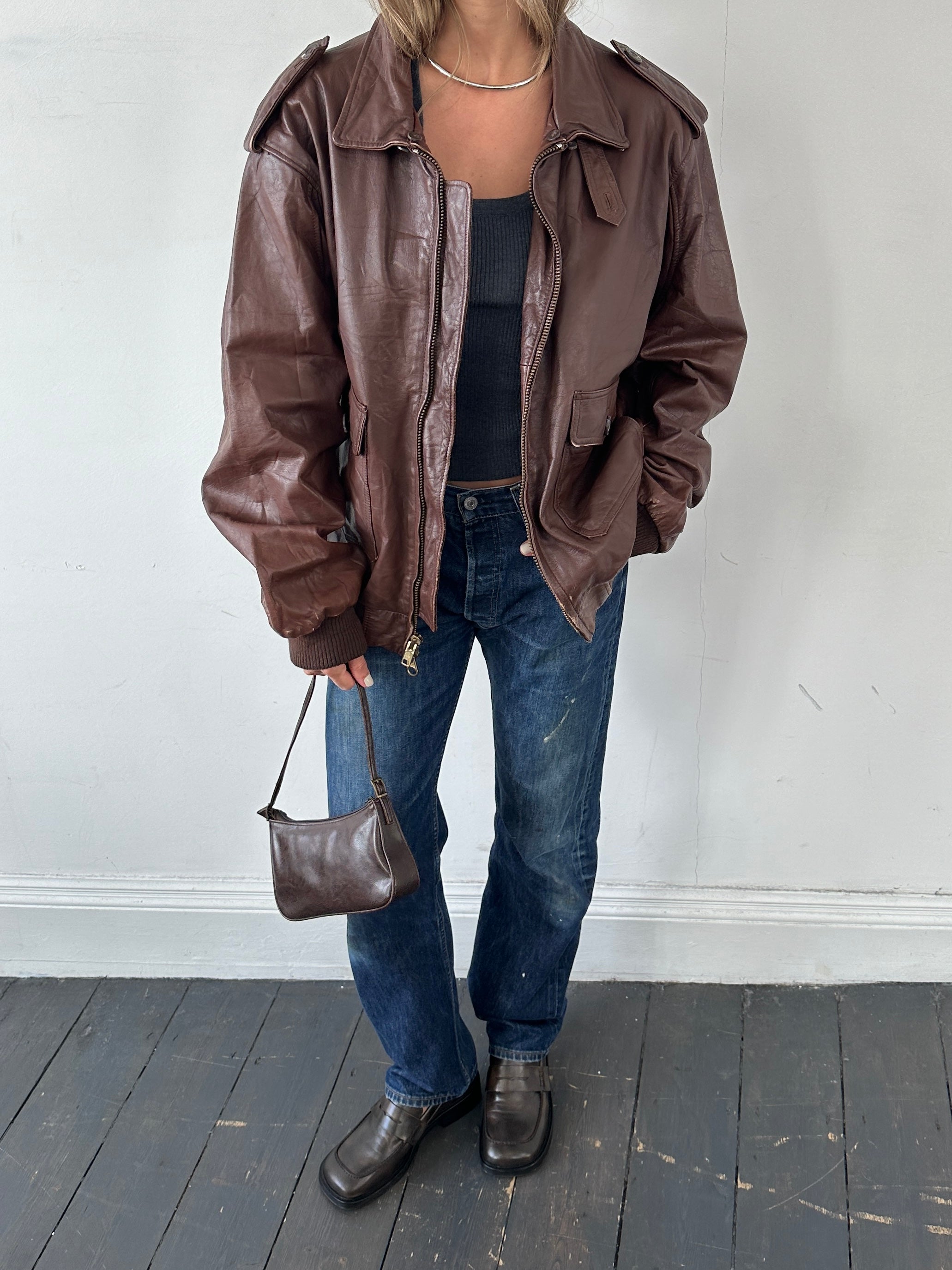 Vintage double zip leather bomber jacket in XL, featuring classic design, worn leather texture, and ribbed cuffs and collar.