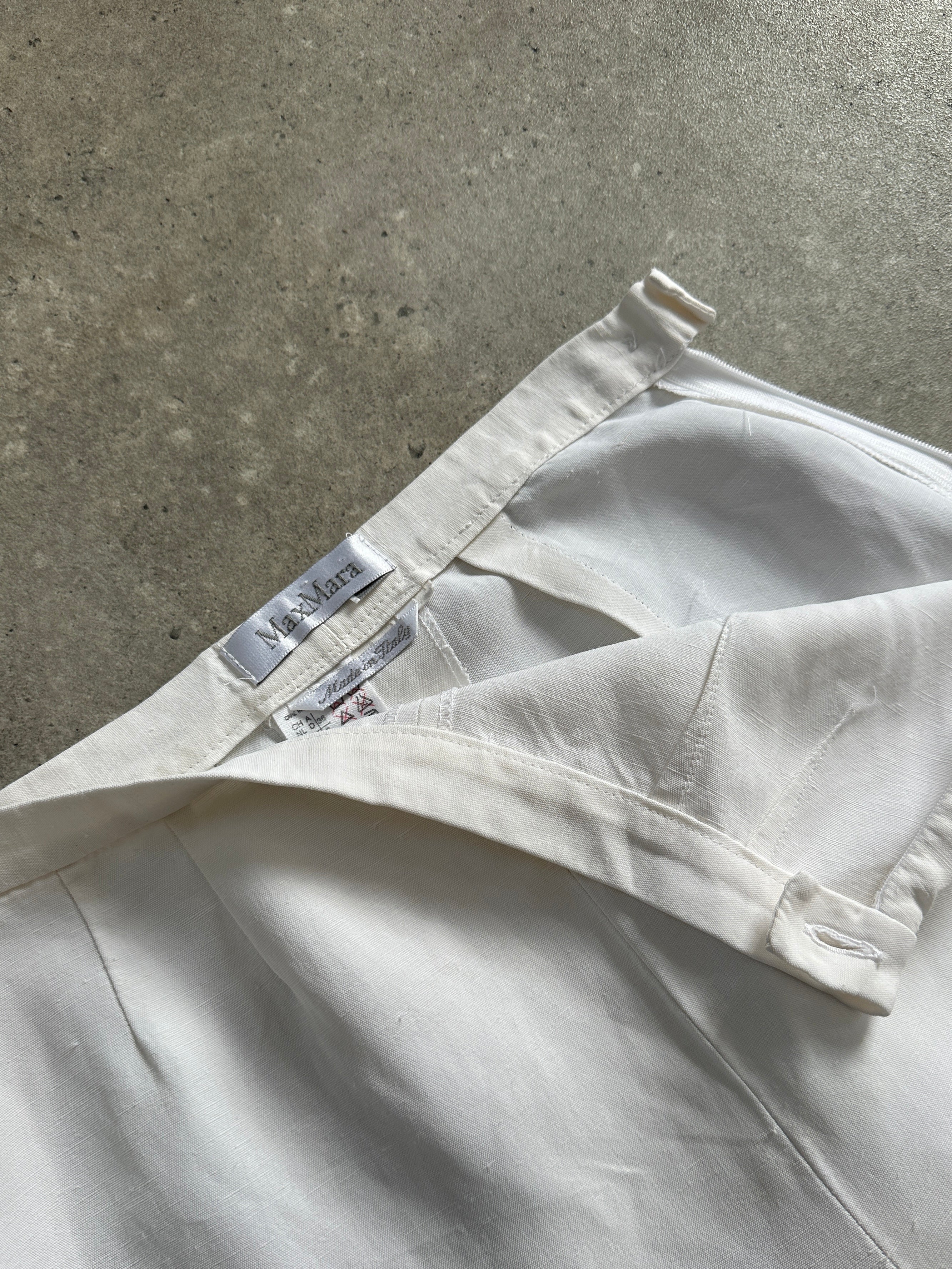 Max Mara linen tapered leg high-waisted trousers in beige, showing front view with belt detail and tailored fit.