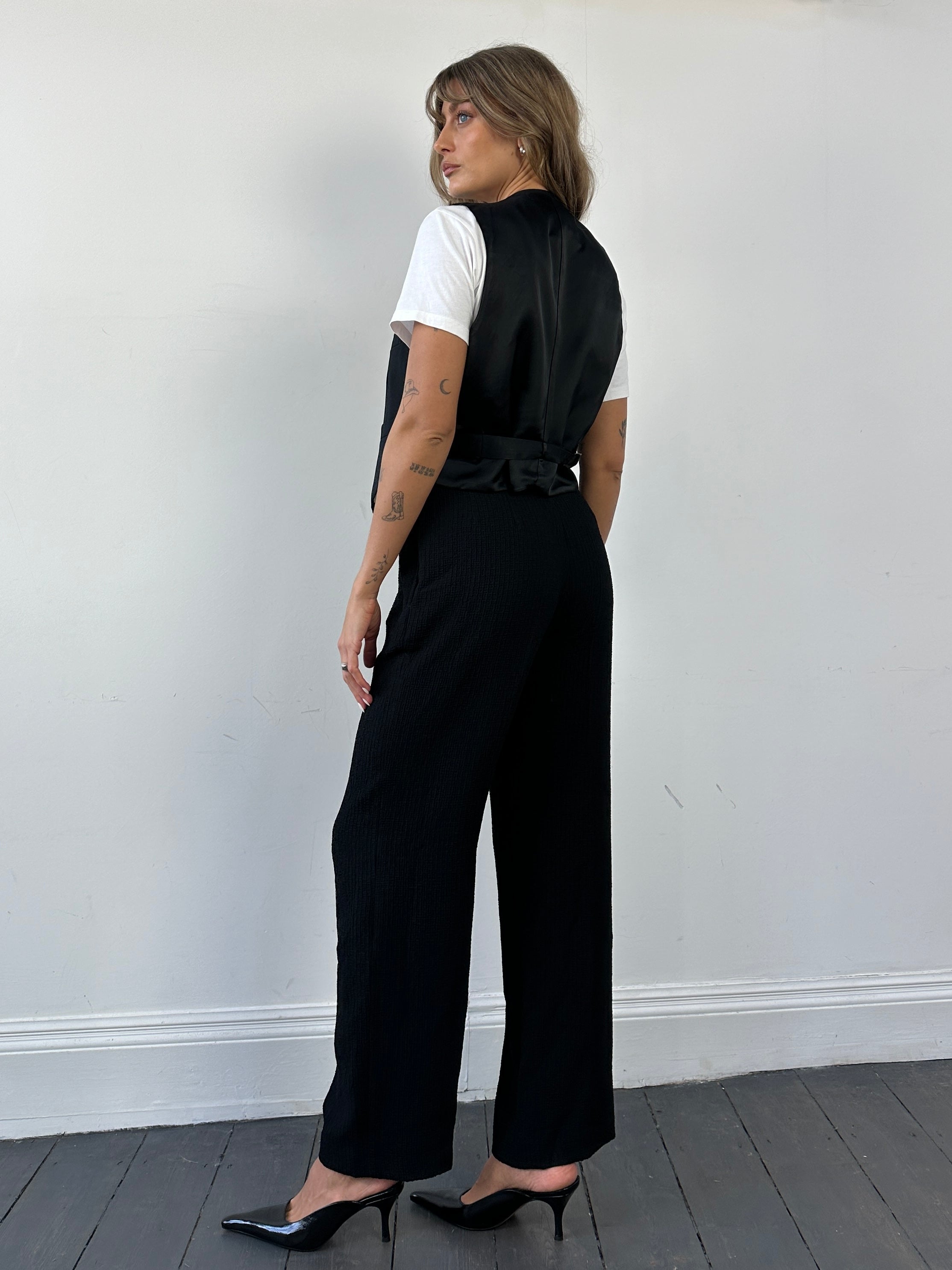 Vintage high waisted textured trousers in W26, showcasing their retro style and fabric detail.