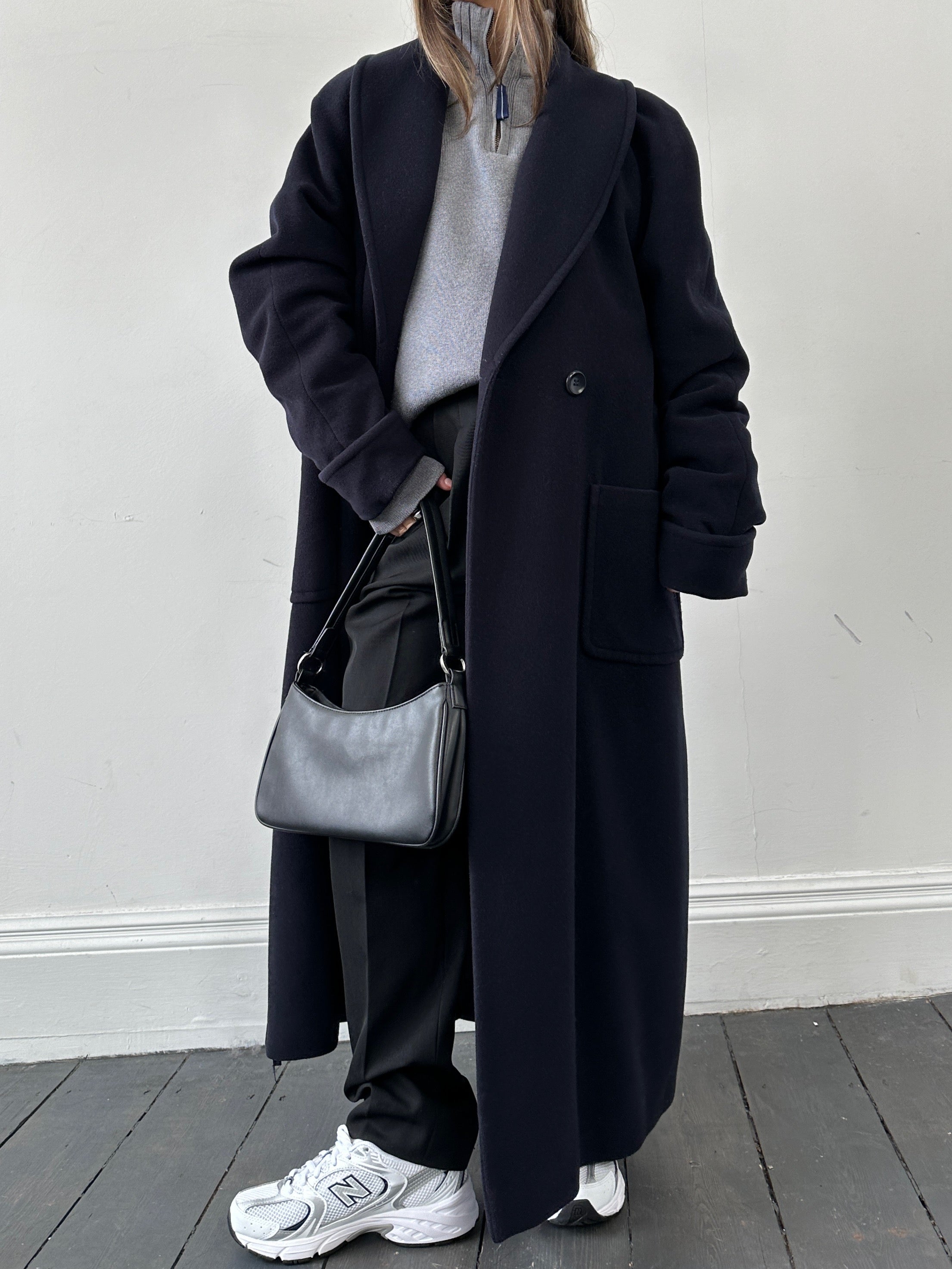 Vintage wool double-breasted coat in size M, featuring classic style and warm fabric, displayed on a hanger.