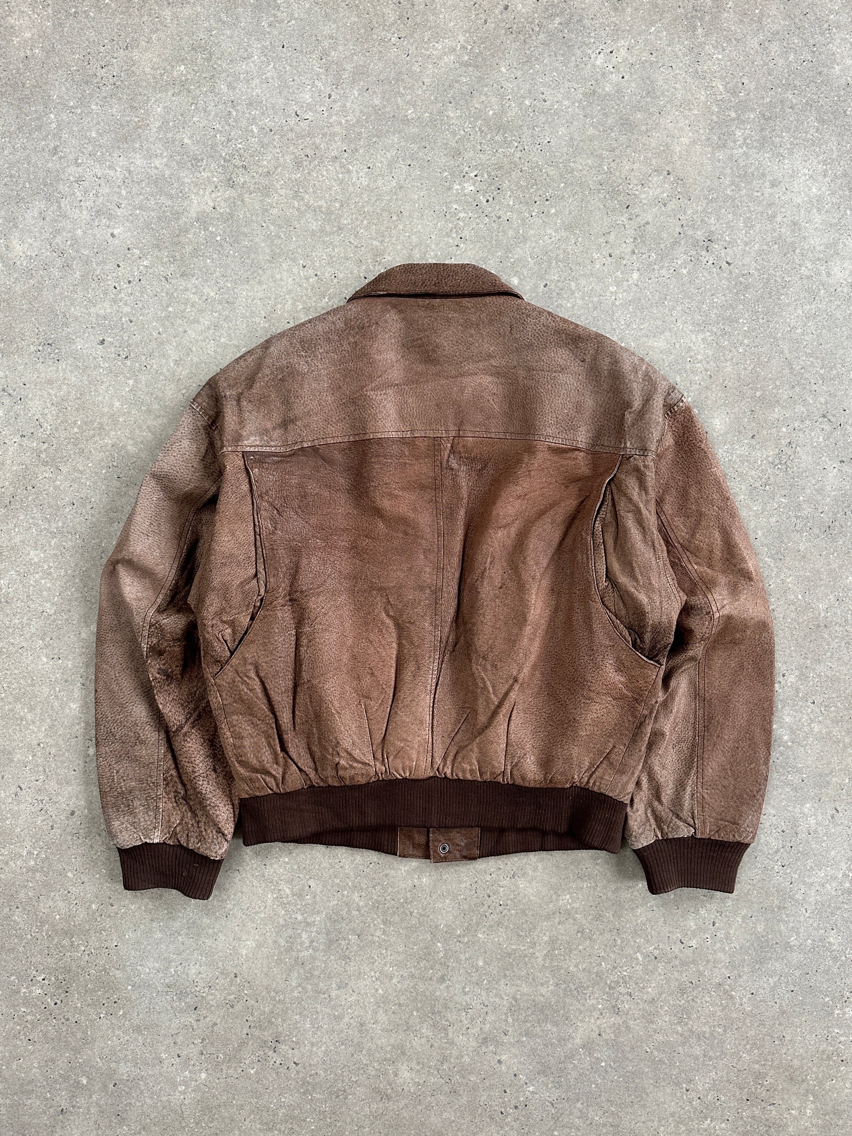 Vintage 1990s leather bomber jacket in size large, featuring classic design and aged leather with ribbed cuffs and collar.