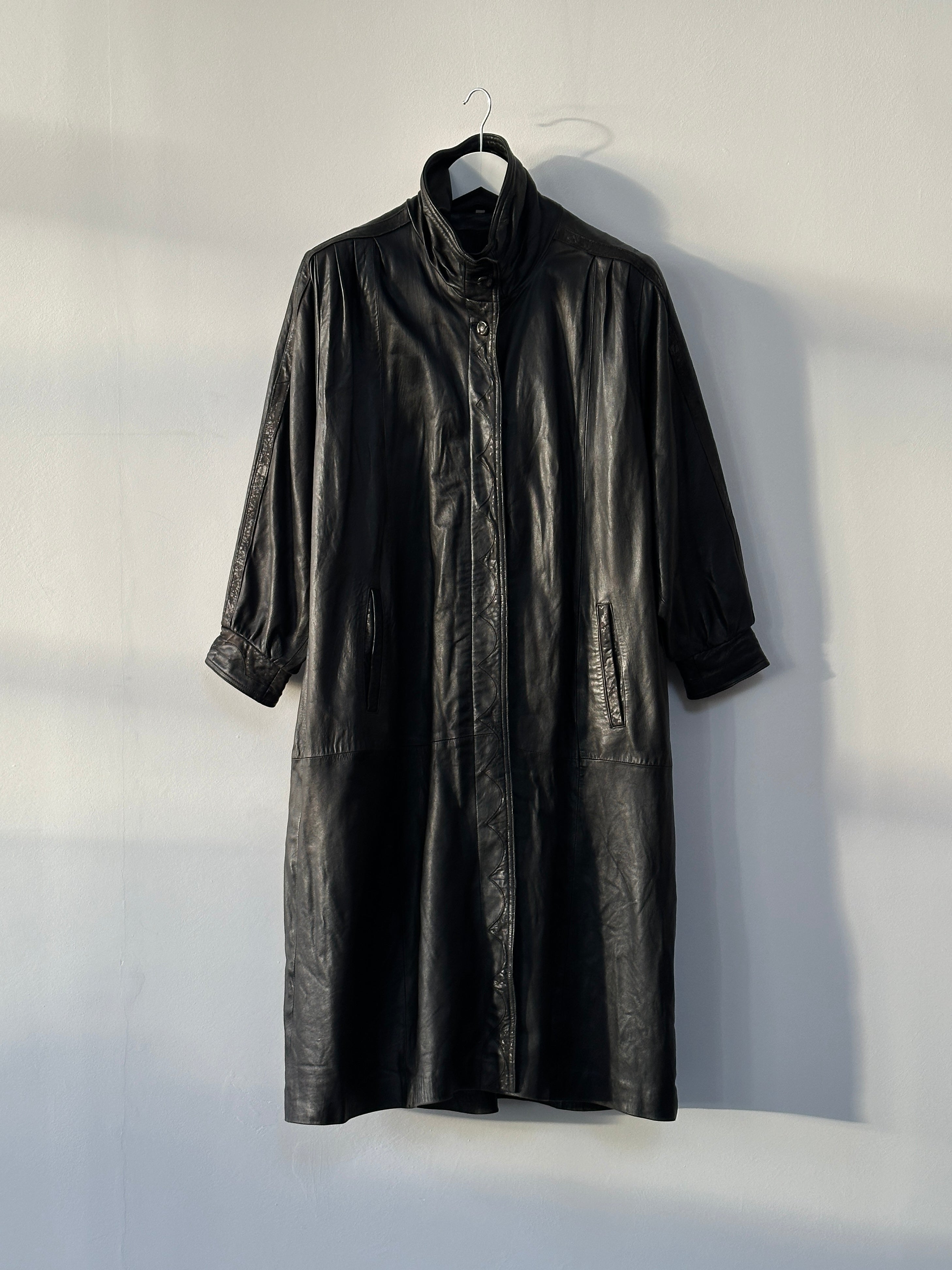 Vintage high neck leather trench coat in XL, stylish and classic, featuring a high neckline and tailored leather design.