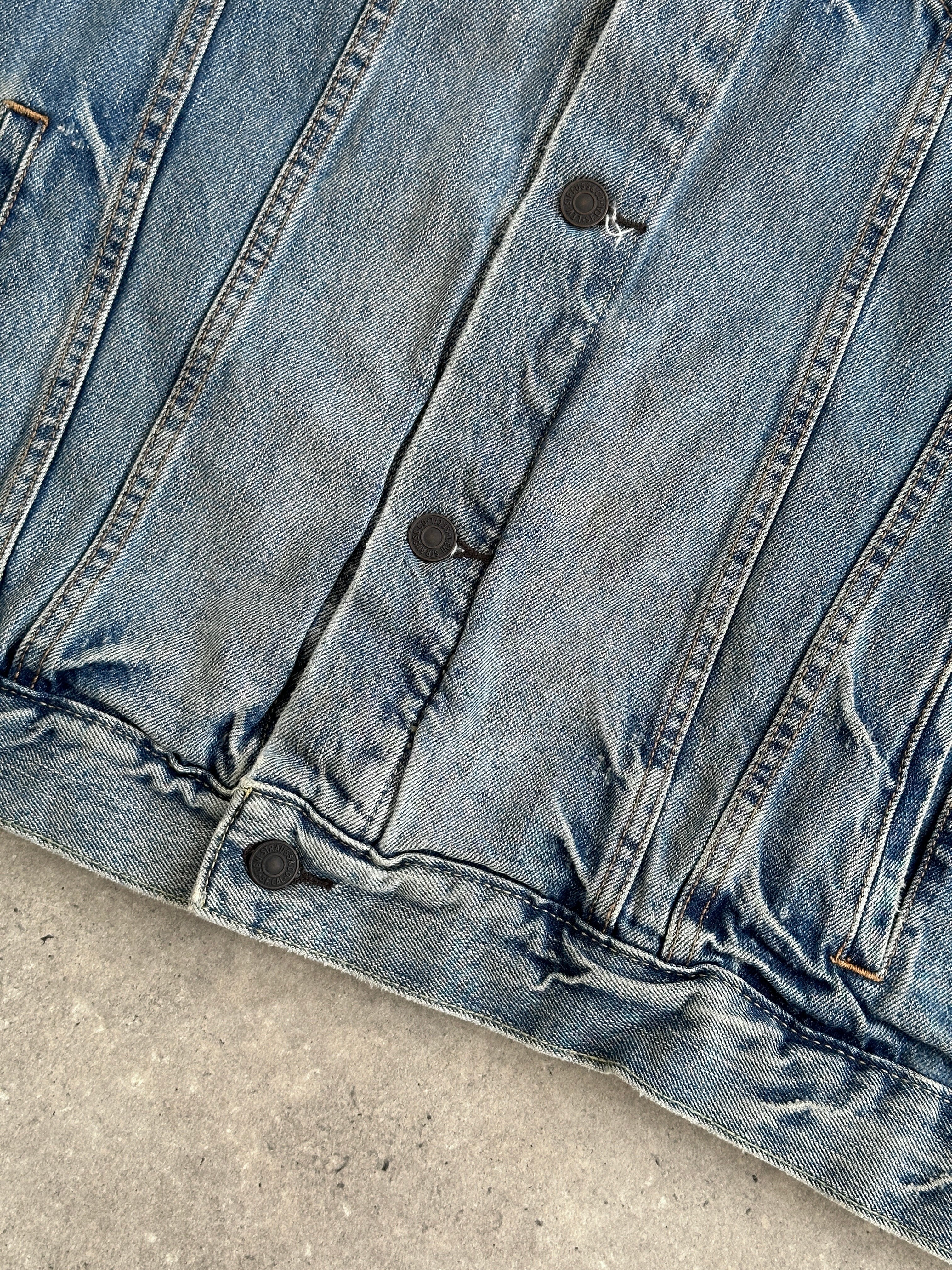 Levi’s 2000s light wash denim jacket in XL with classic fit and button-front design, shown on a hanger.