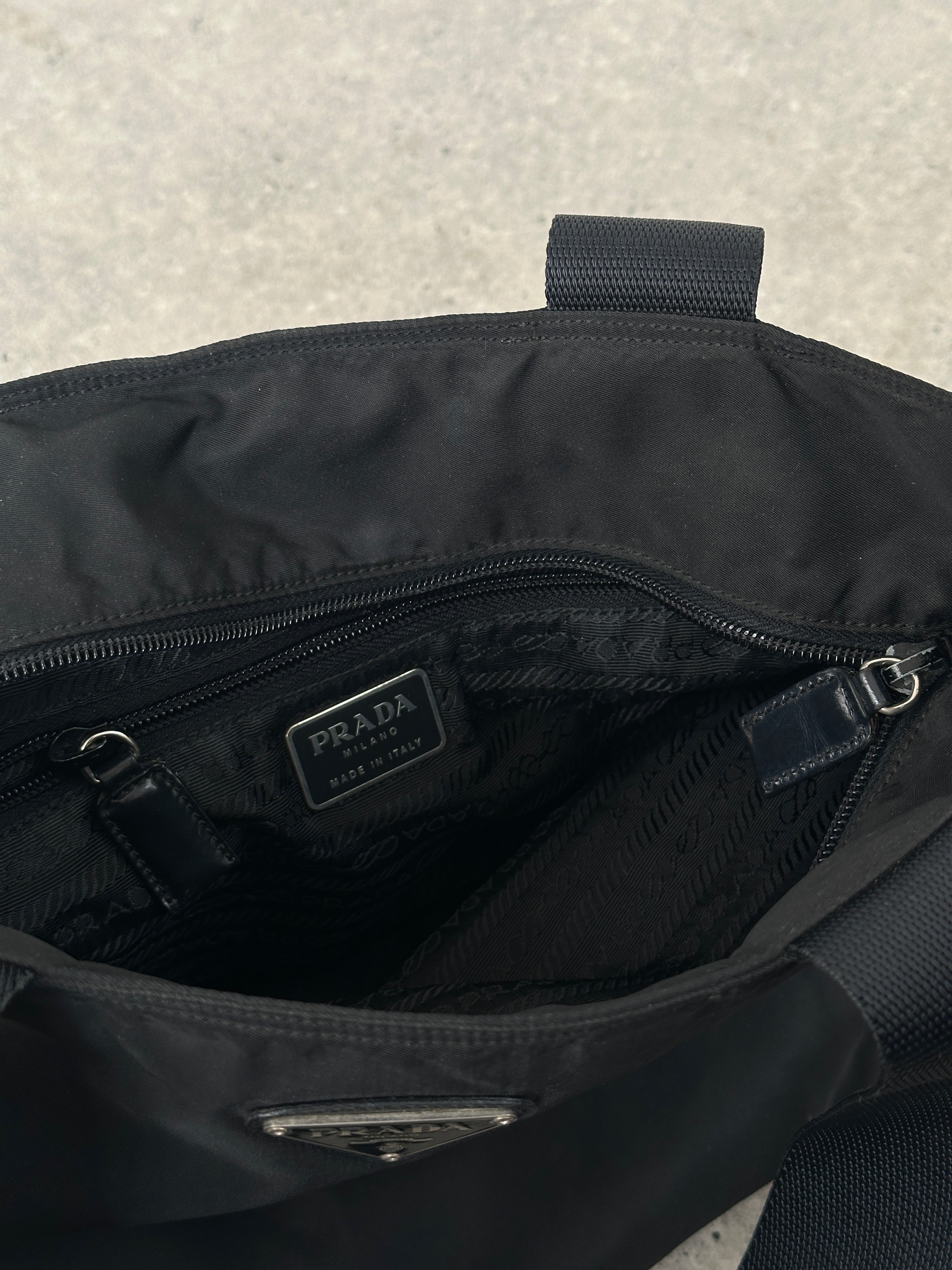 Prada 1997 nylon shoulder bag with sleek design, featuring adjustable strap and signature Prada logo on the front.