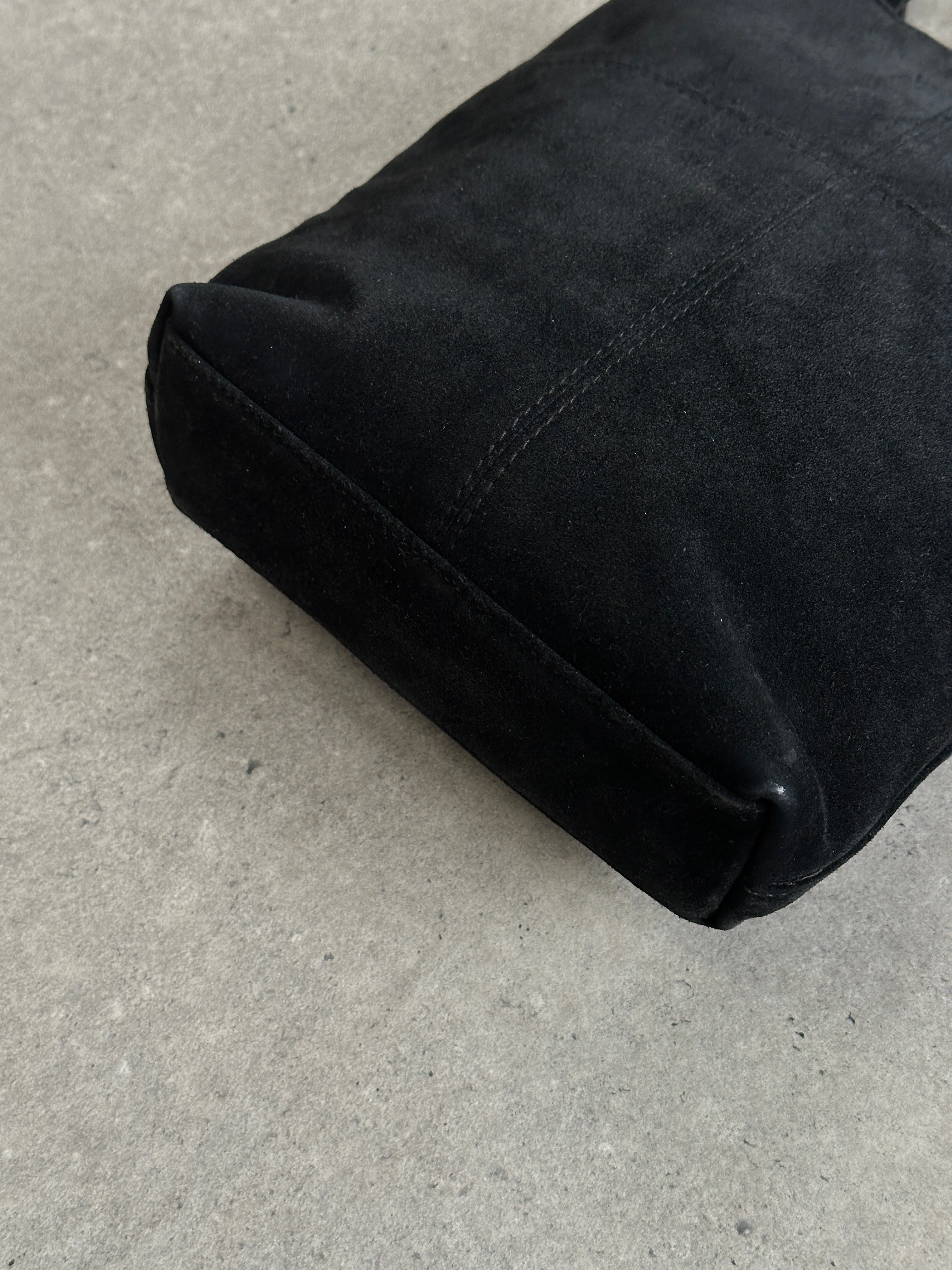 Gucci 2000s suede top handle crossbody bag with sleek design and adjustable strap, featuring classic Gucci branding.