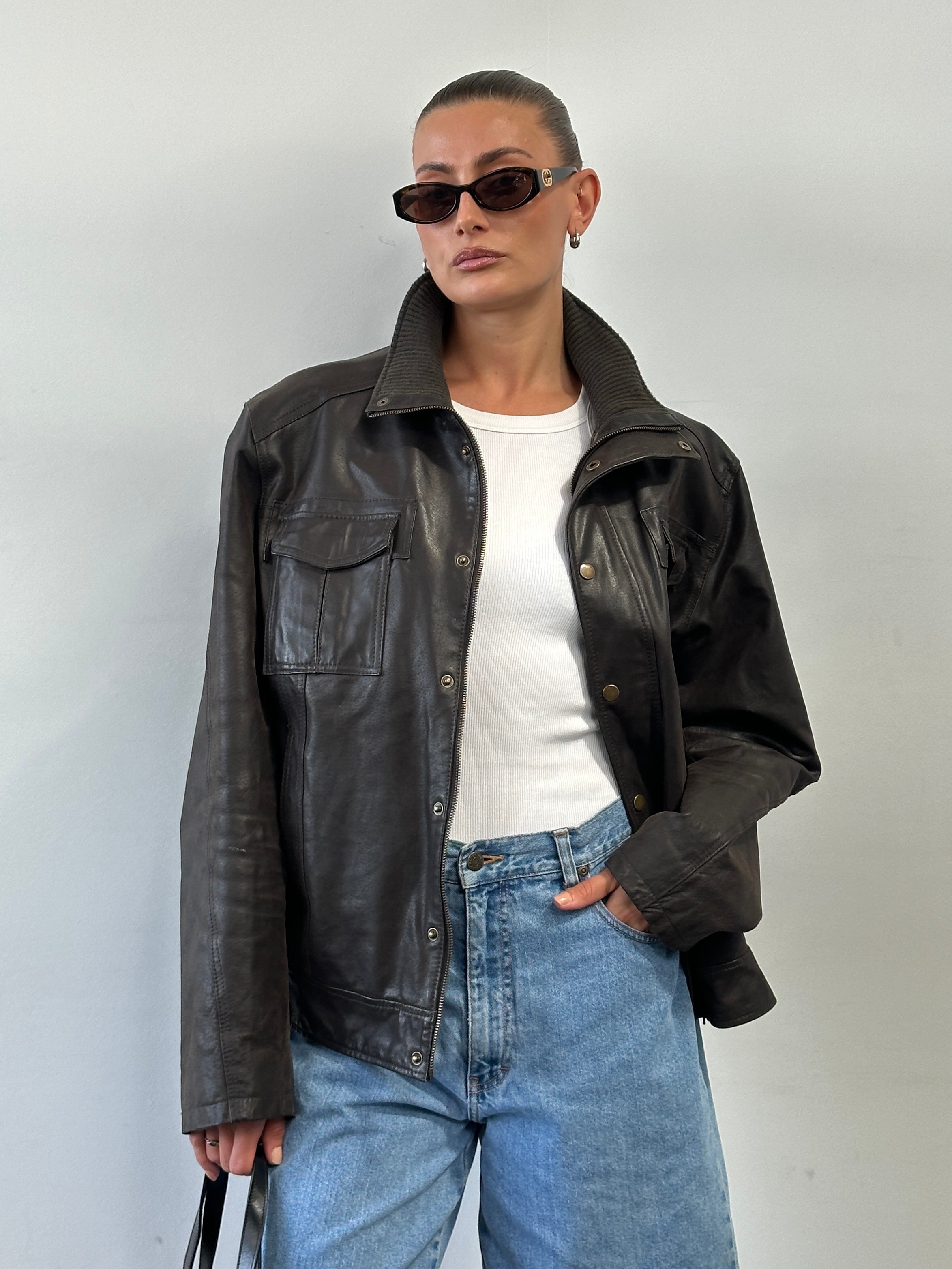 Vintage high neck leather jacket in XL size, featuring classic style, smooth leather, and detailed stitching.