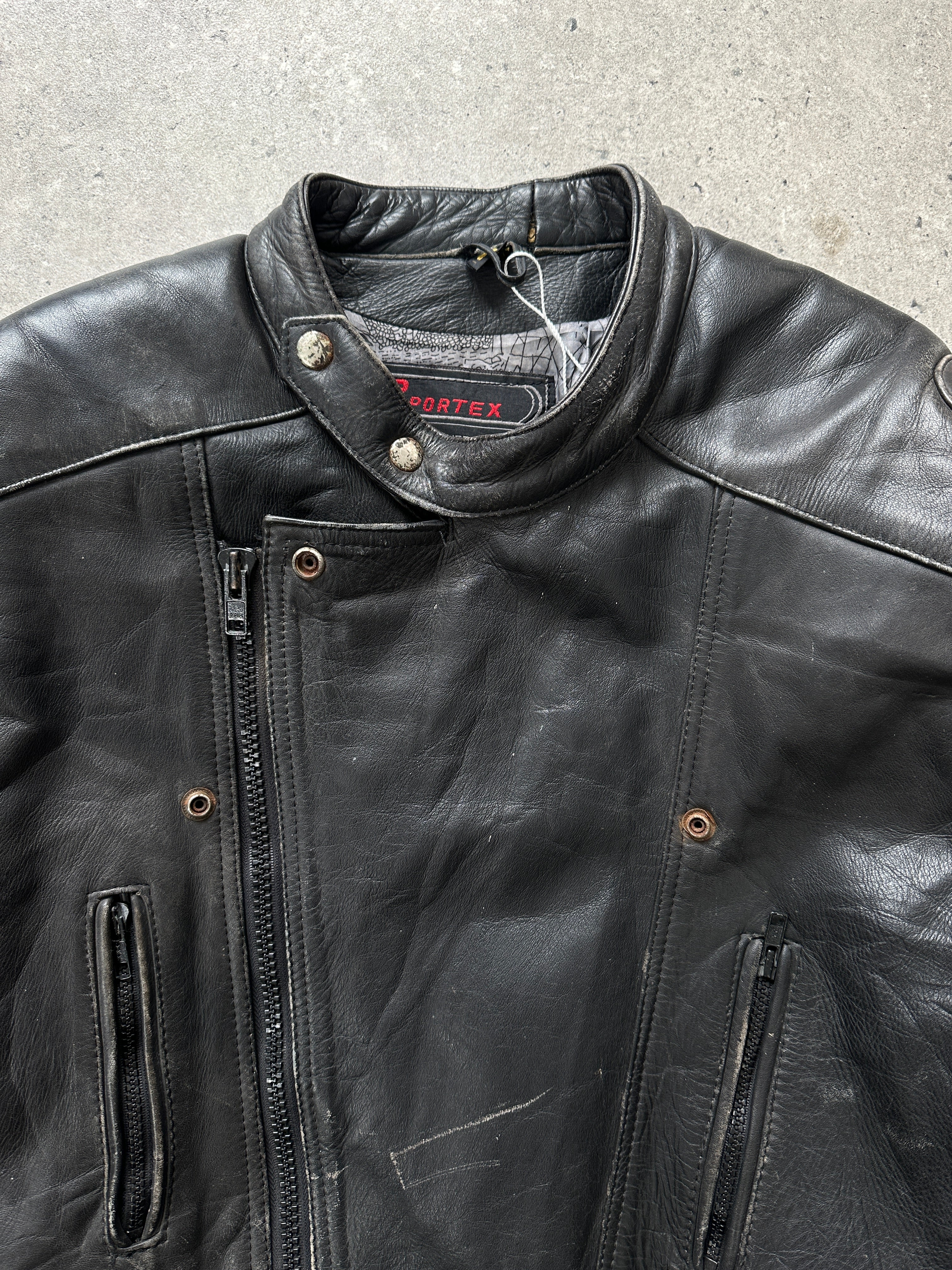 Vintage distressed leather motorcycle jacket in size L/XL, featuring rugged design and classic biker style.