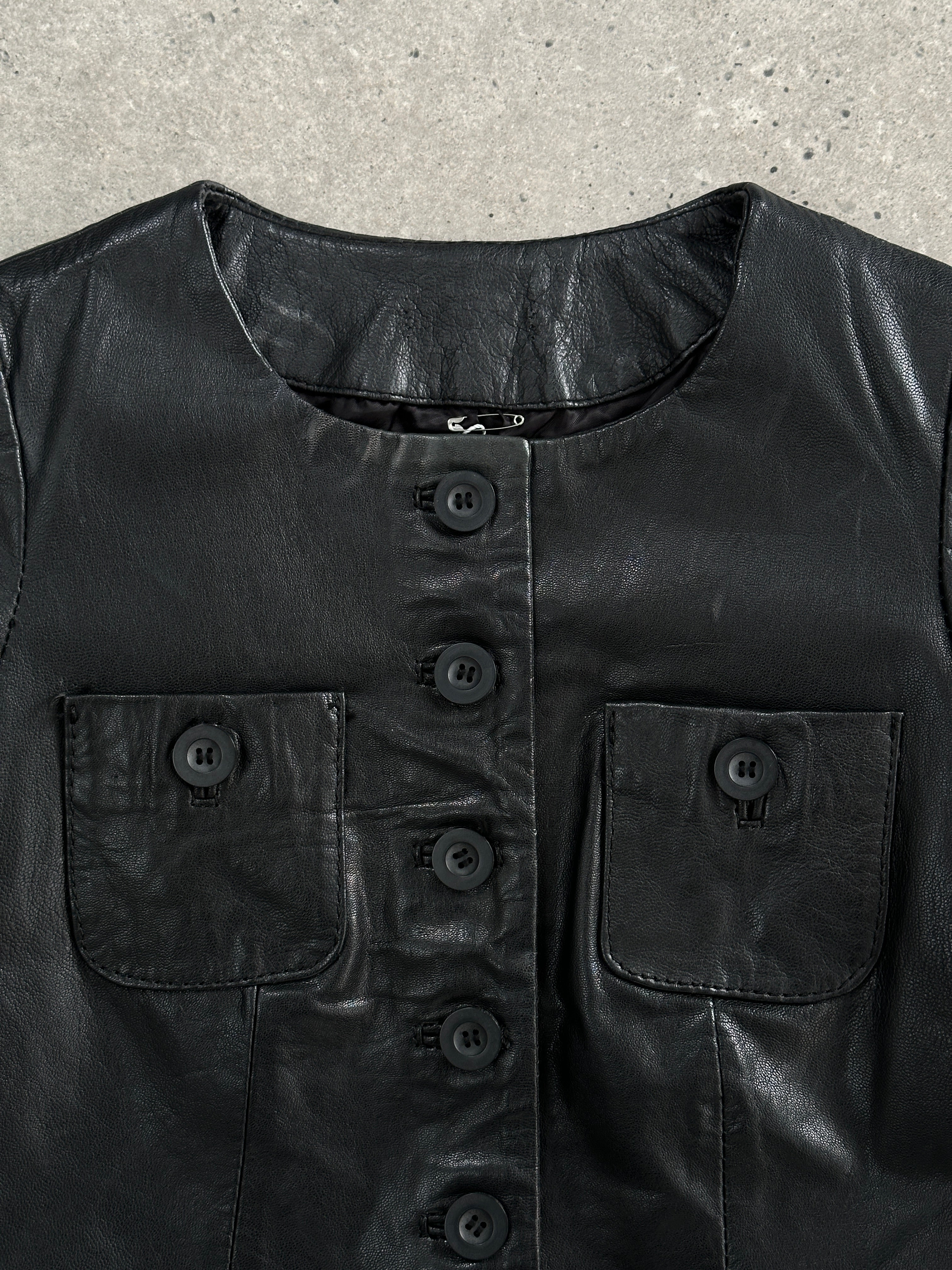 Vintage leather mini dress in size S, featuring classic design and rich texture, perfect for stylish vintage fashion.