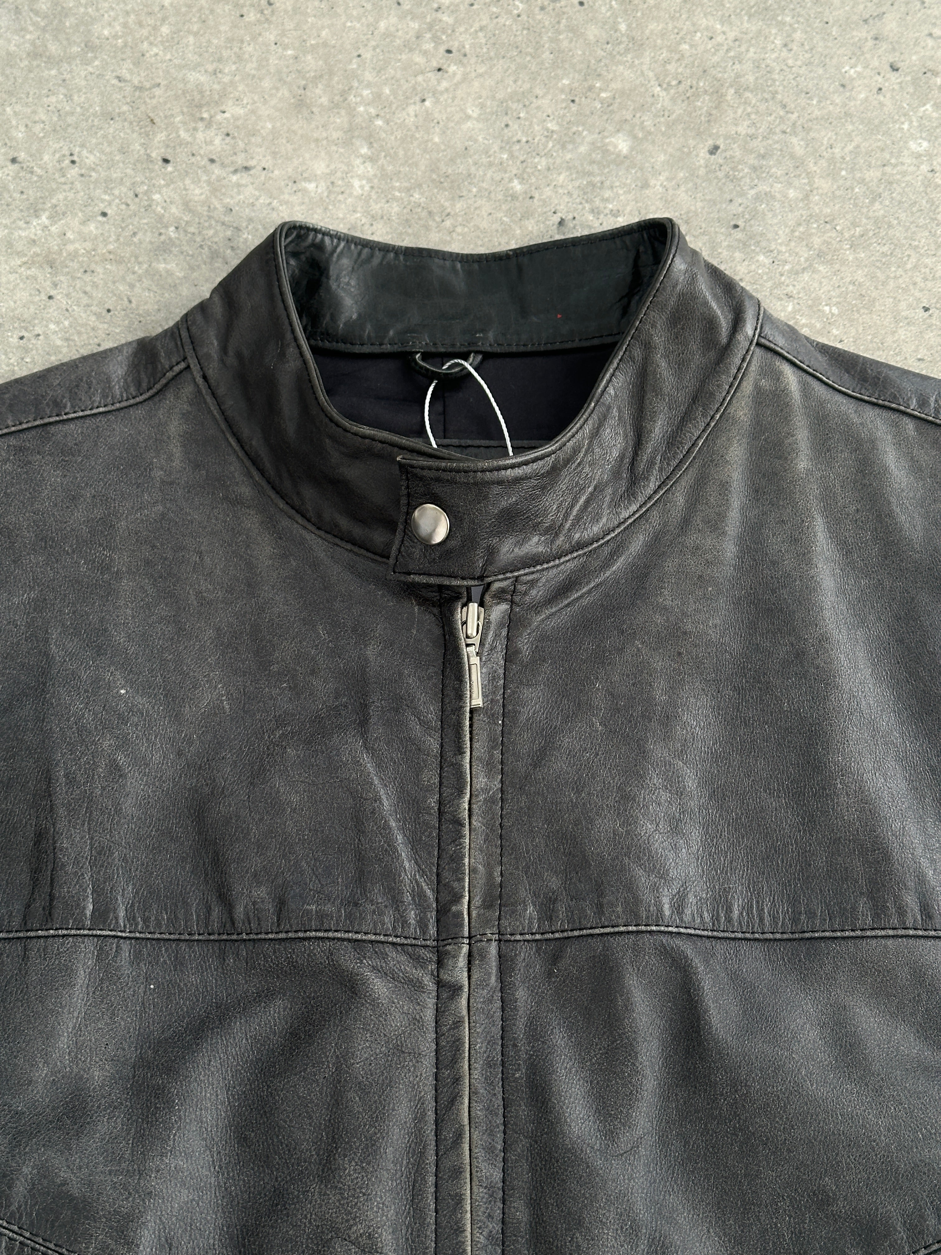 Vintage distressed leather motorcycle jacket in size L/XL with rugged, worn-in look and classic design.