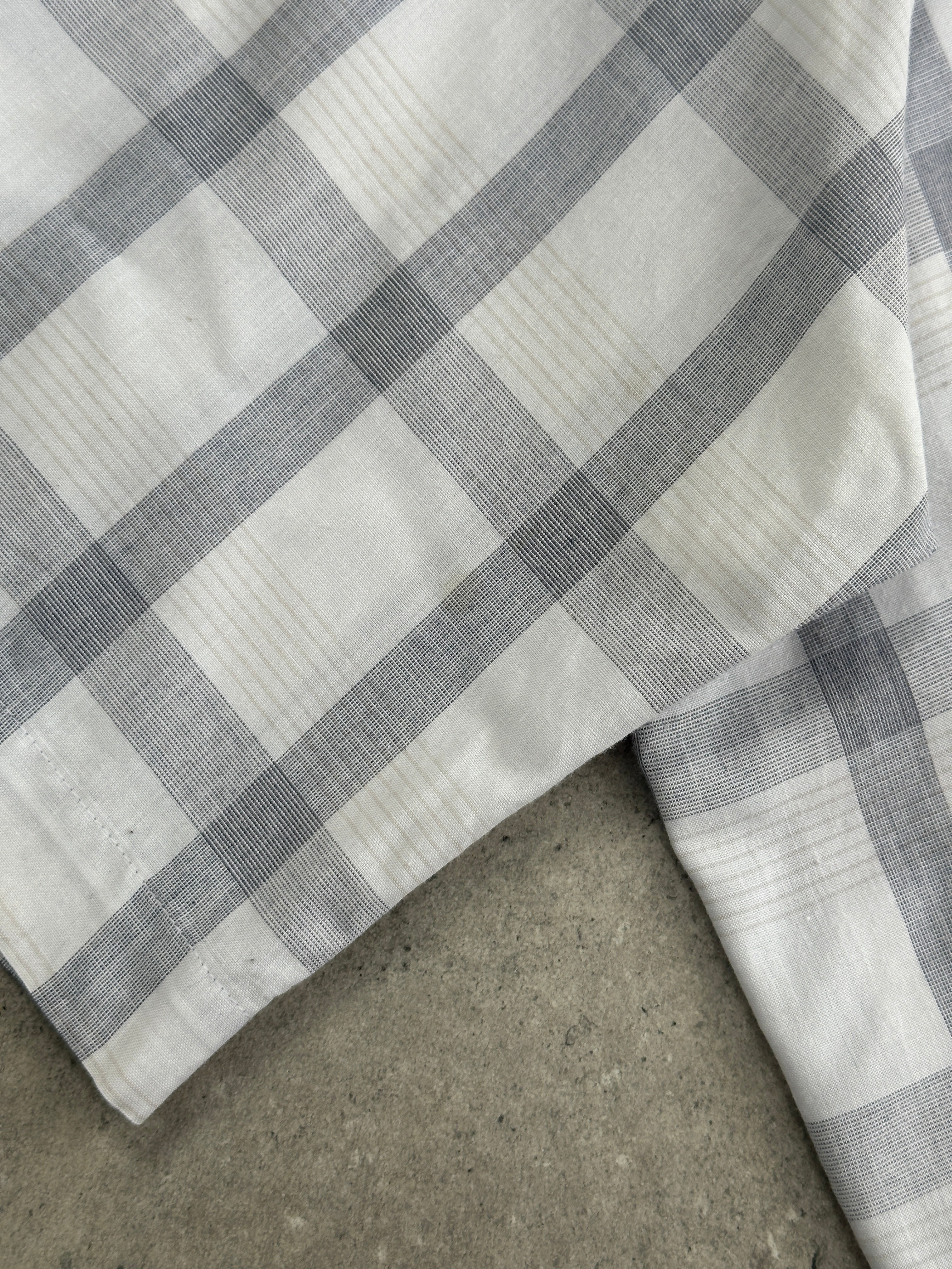 Christian Dior 1990s check cotton shirt in XL size, featuring classic pattern and collared design, displayed flat.
