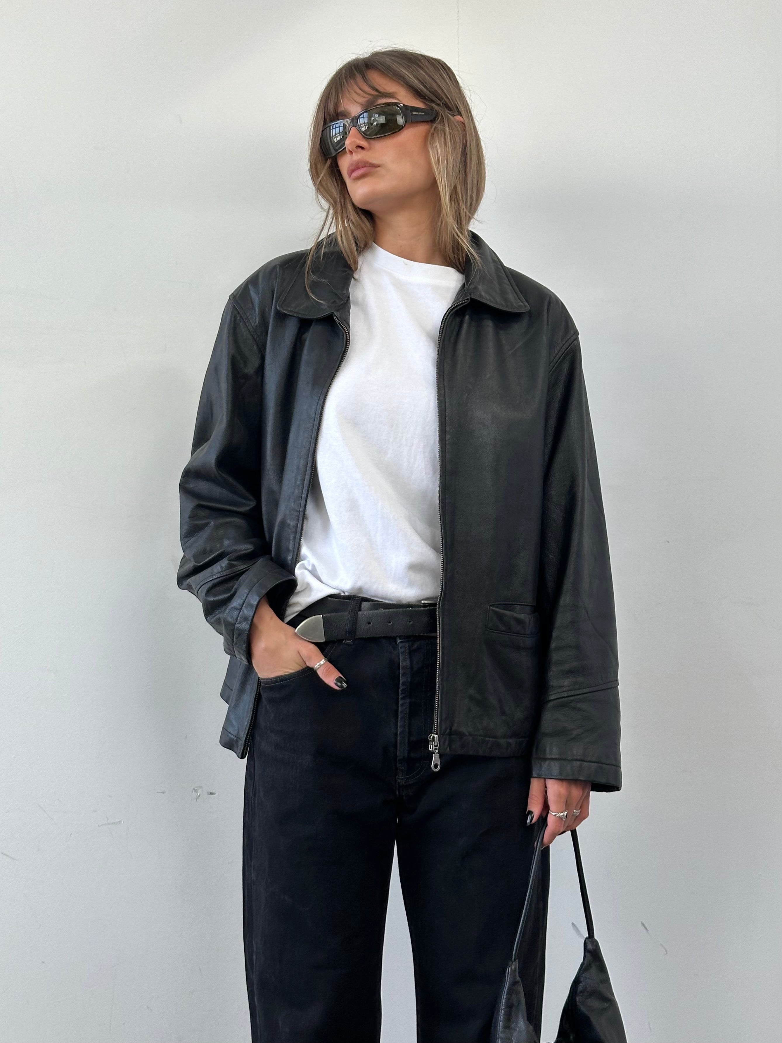 Vintage leather bomber jacket in XL size, featuring a classic design with a smooth leather finish and ribbed cuffs.