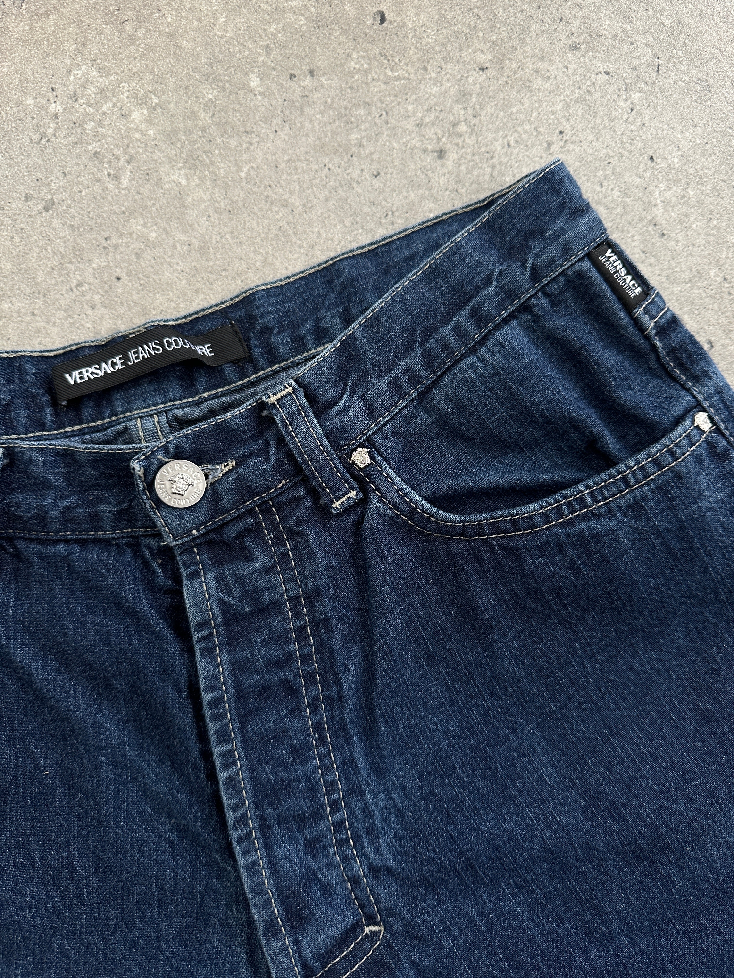 Versace Jeans Couture mid-wasted denim jeans in W27 with classic blue wash and stylish distressed details.
