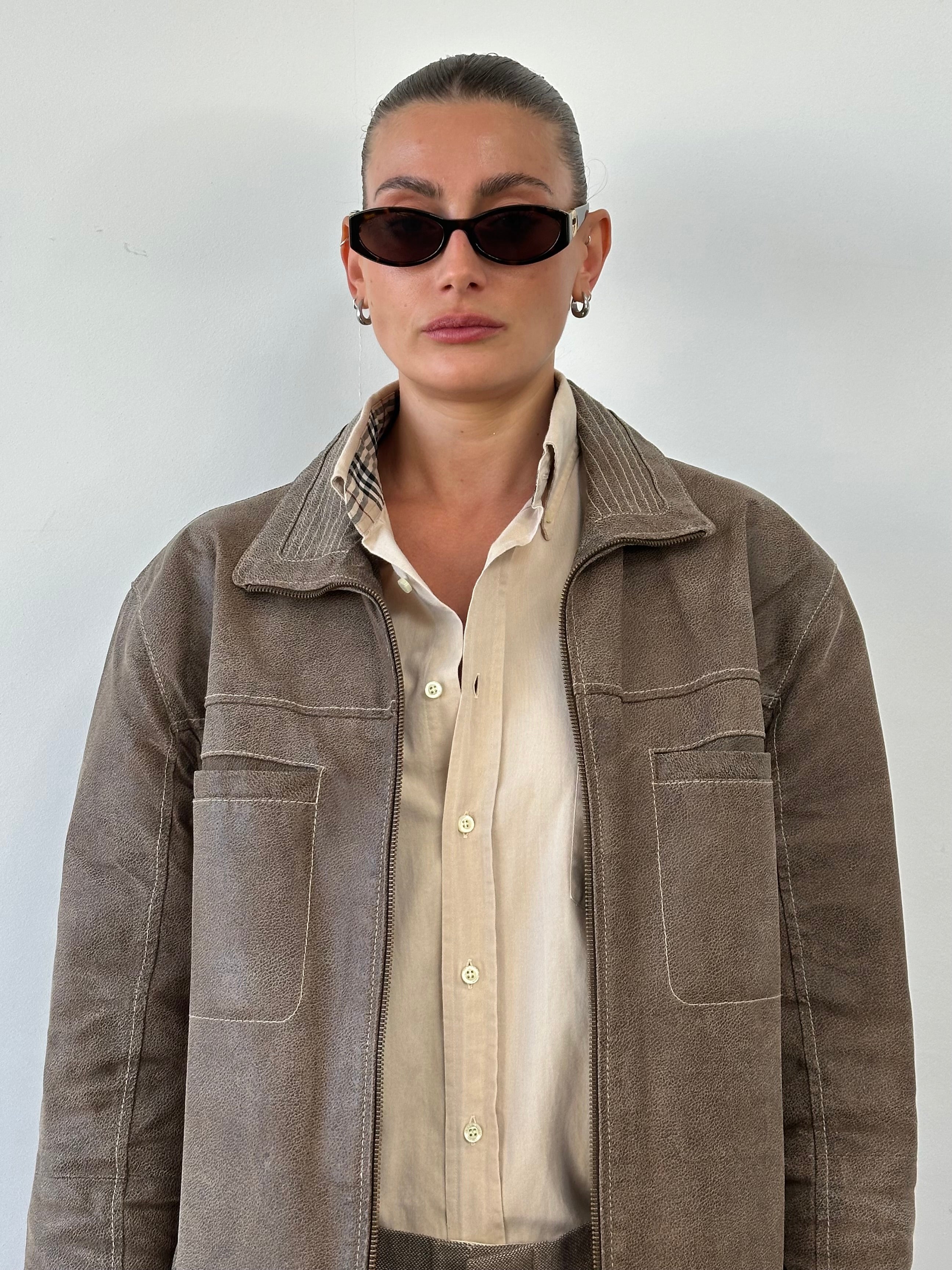 Vintage textured high neck leather jacket in XL, featuring a stylish design and classic leather material, shown on a model.