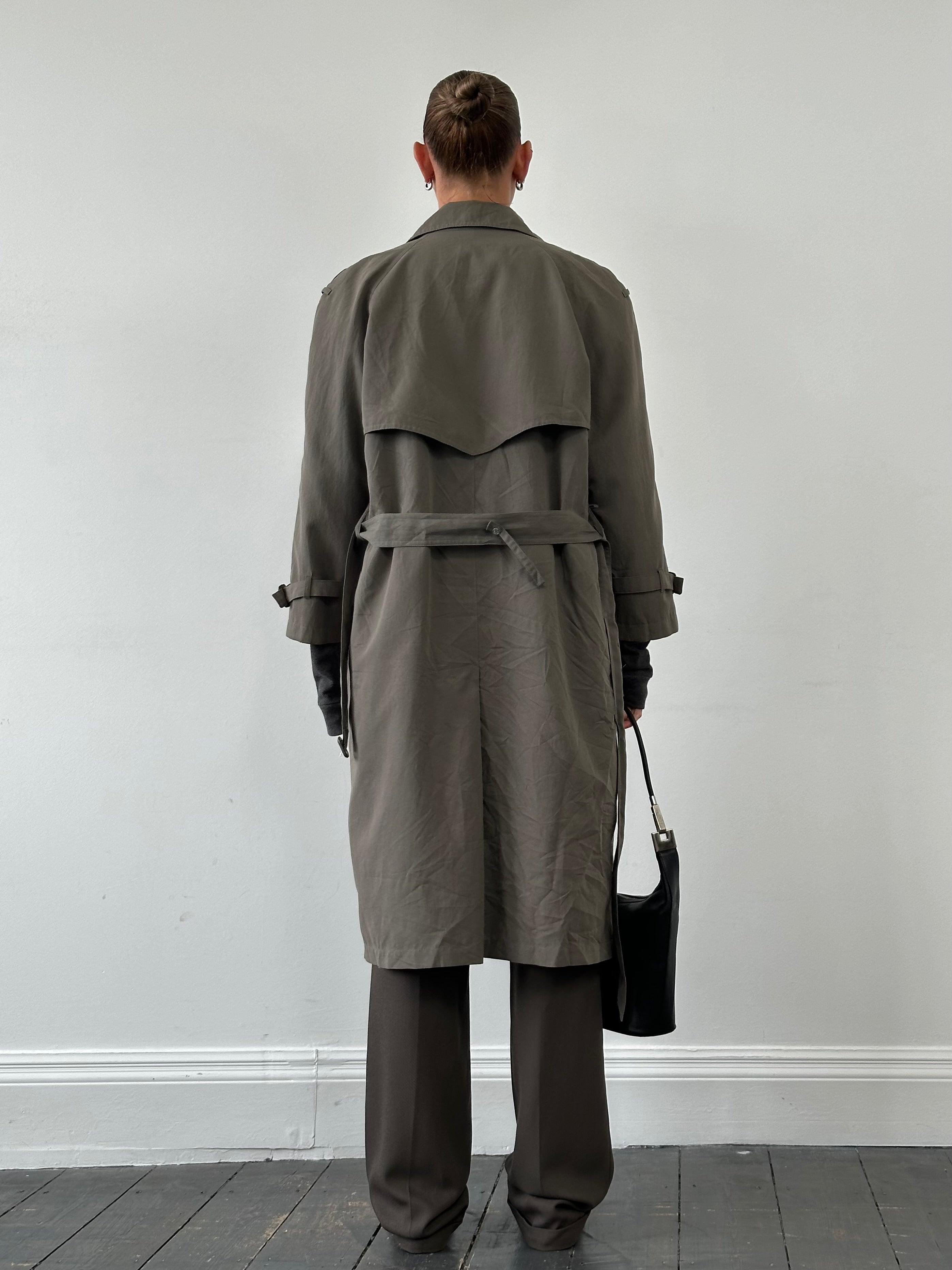London Fog double-breasted trench coat in size S/M, shown on a hanger with classic beige fabric and button details.